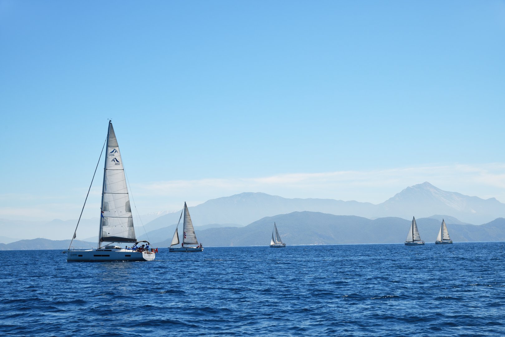 Fethiye harbor, Turkey - April 26, 2024: Sailing cruise in Turkey. Beautiful white yachts, sailboats or sail boats sailing at sea on a calm, bright sunny day