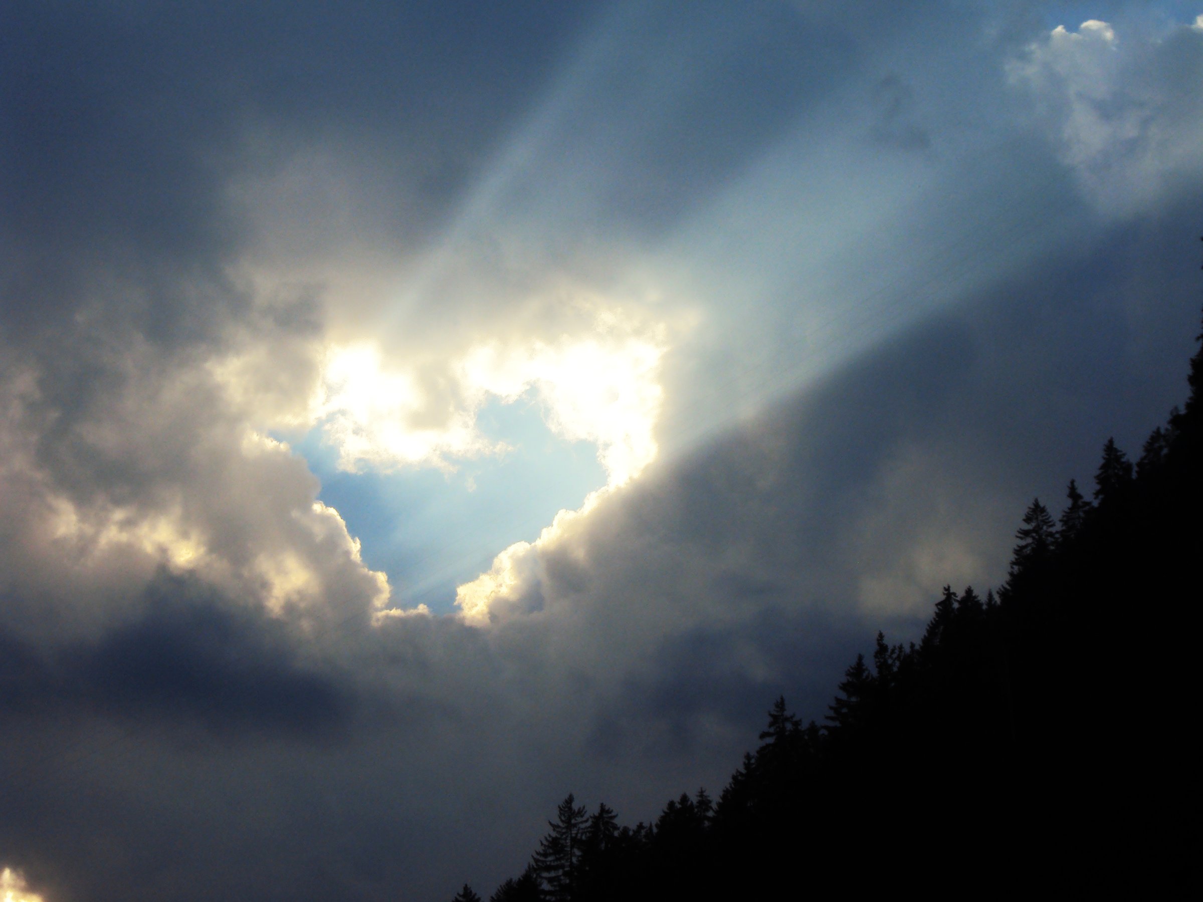 The rays of the evening sun that penetrate through the clouds of the heavenly heart - Canton of Uri, Switzerland