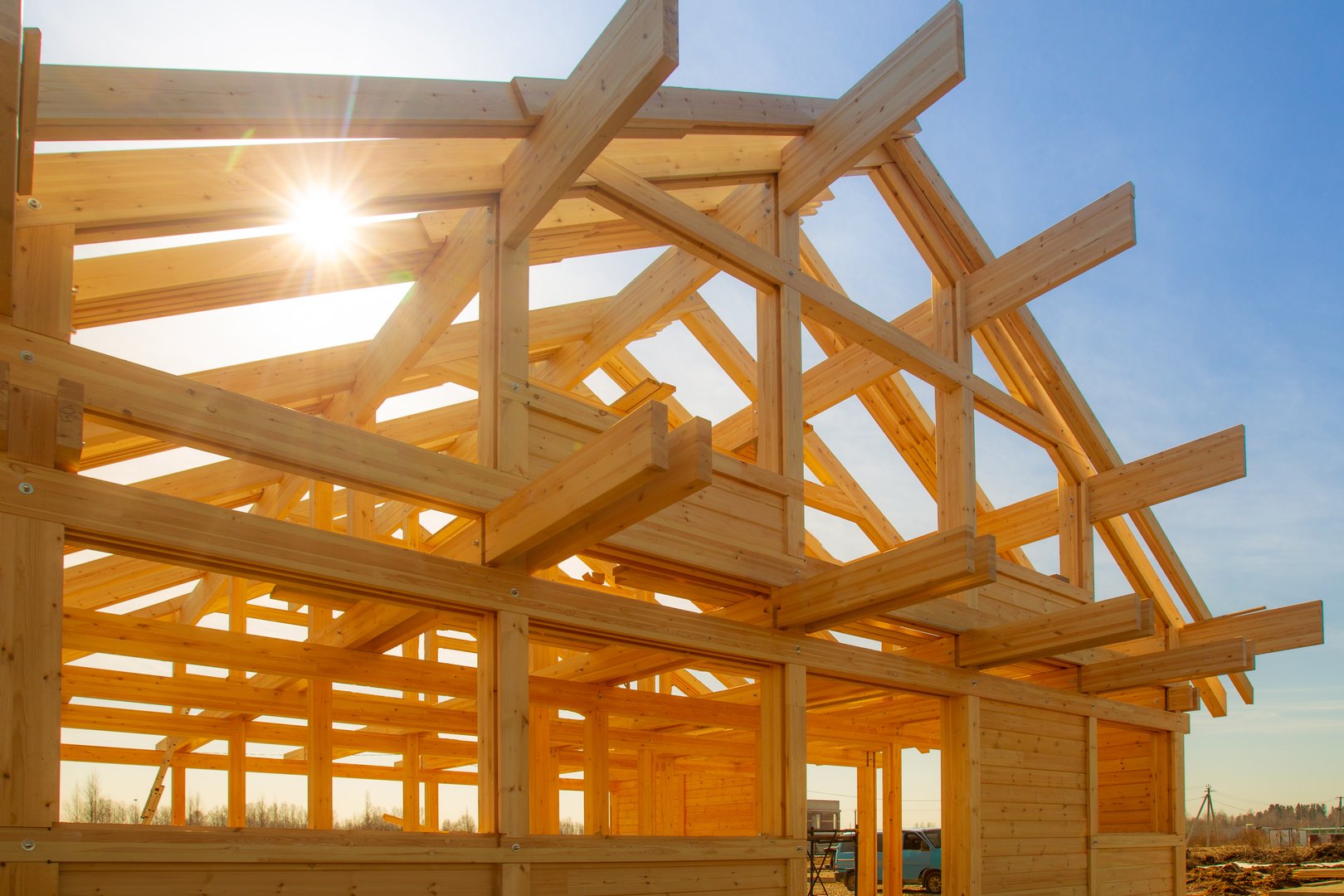 Frame of building house. Construction of the cottage timber. The wooden base of the house. Construction site sunlit. Building of private house.