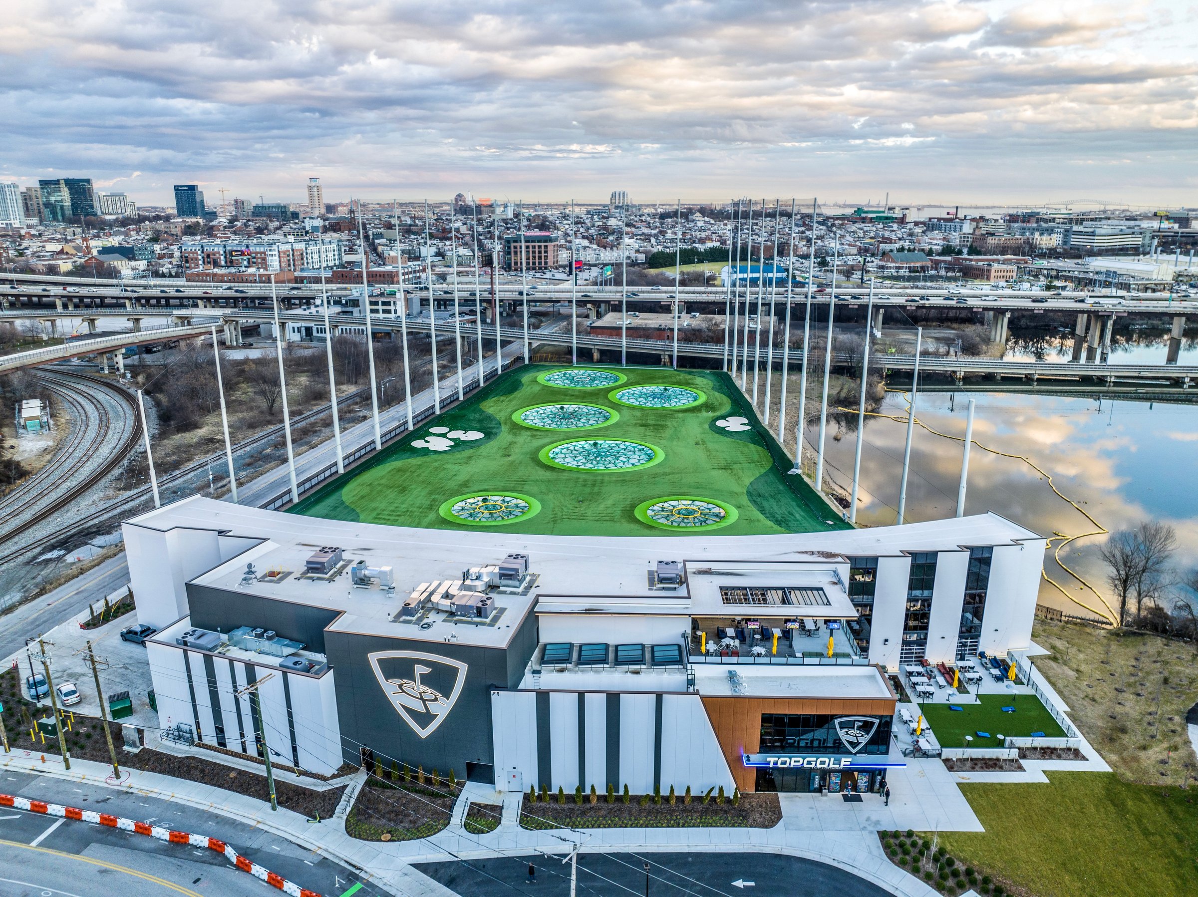 Baltimore, MD, USA - January 5, 2023: The image is of Topgolf, Baltimore City's newest attraction and event venue. The 21st century driving range is located near M&T Bank Stadium and Horseshoe Casino in a neighborhood now called the 'Entertainment District.' The image is taken from above ground level via drone with no identifiable people in the photo.