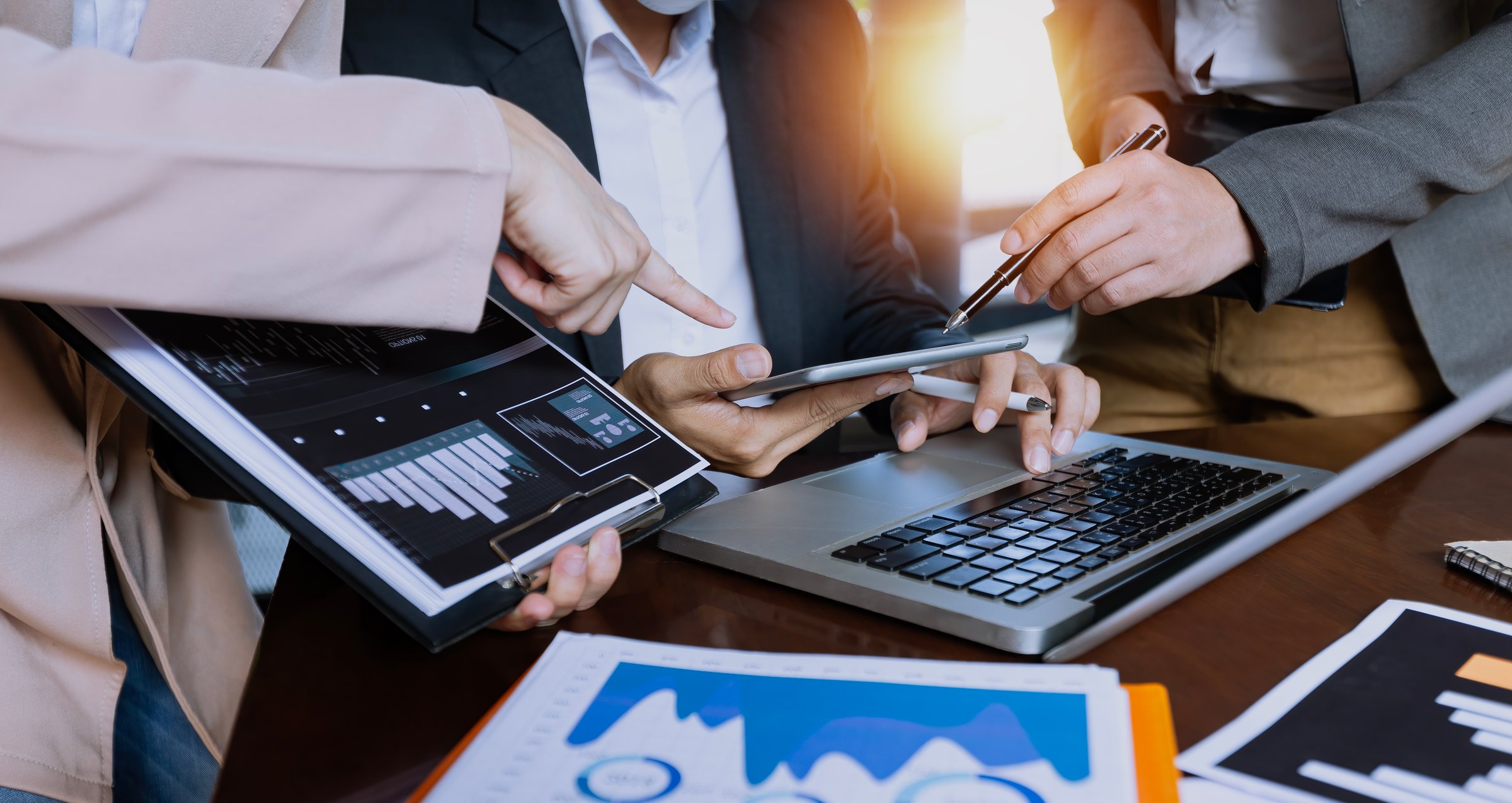 Technology and financial advisory services concept. Business people and working on digital computer with advisor showing plan of investment to clients at table office. Digital marketing.