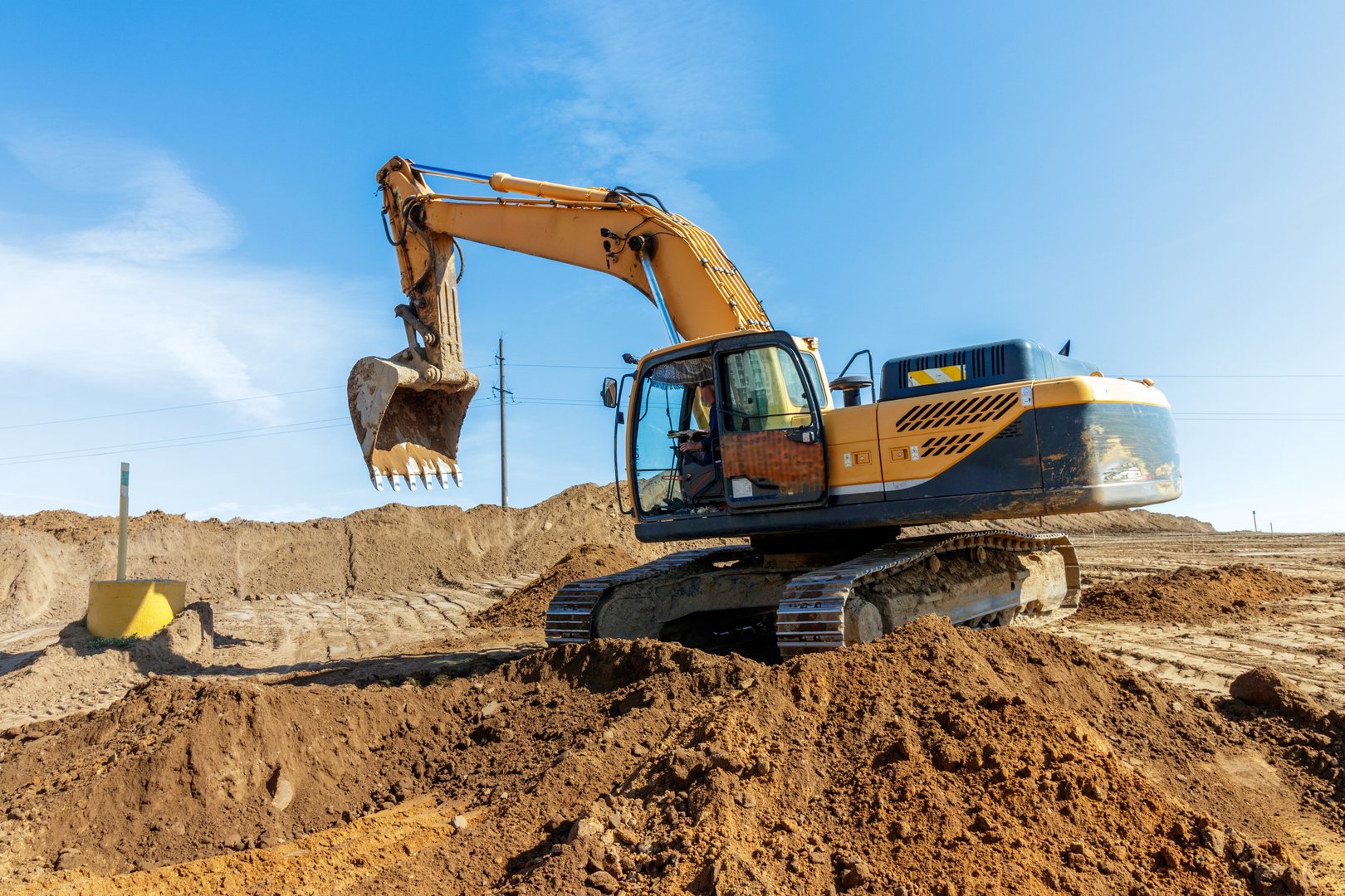 A dynamic image capturing a strong excavator in action at a construction site, ideal for illustrating industrial strength and progress