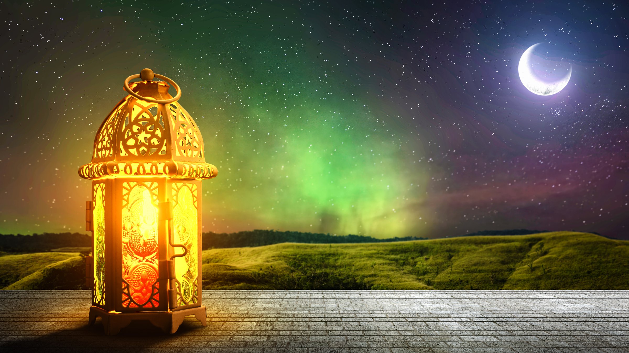 Traditional glowing Arabic lantern on the field with night scene background. Copy space. Concept of Religion, Spiritual or Ramadan