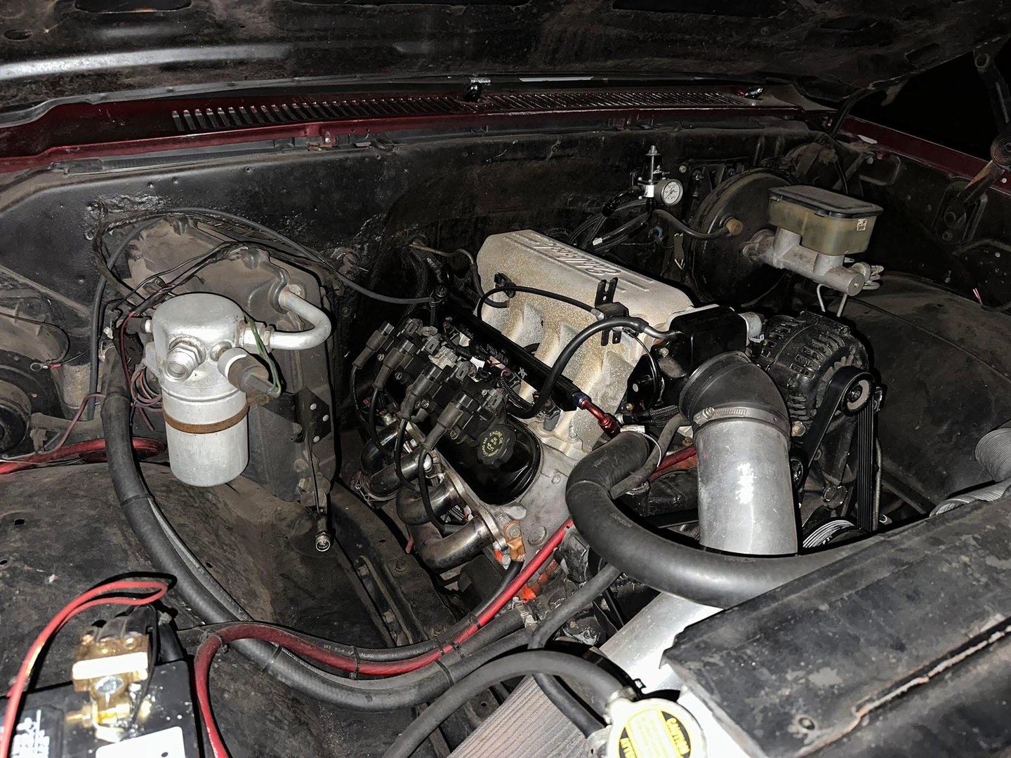 Professional mechanic performing ECU diagnostics and custom tuning with laptop in automotive garage