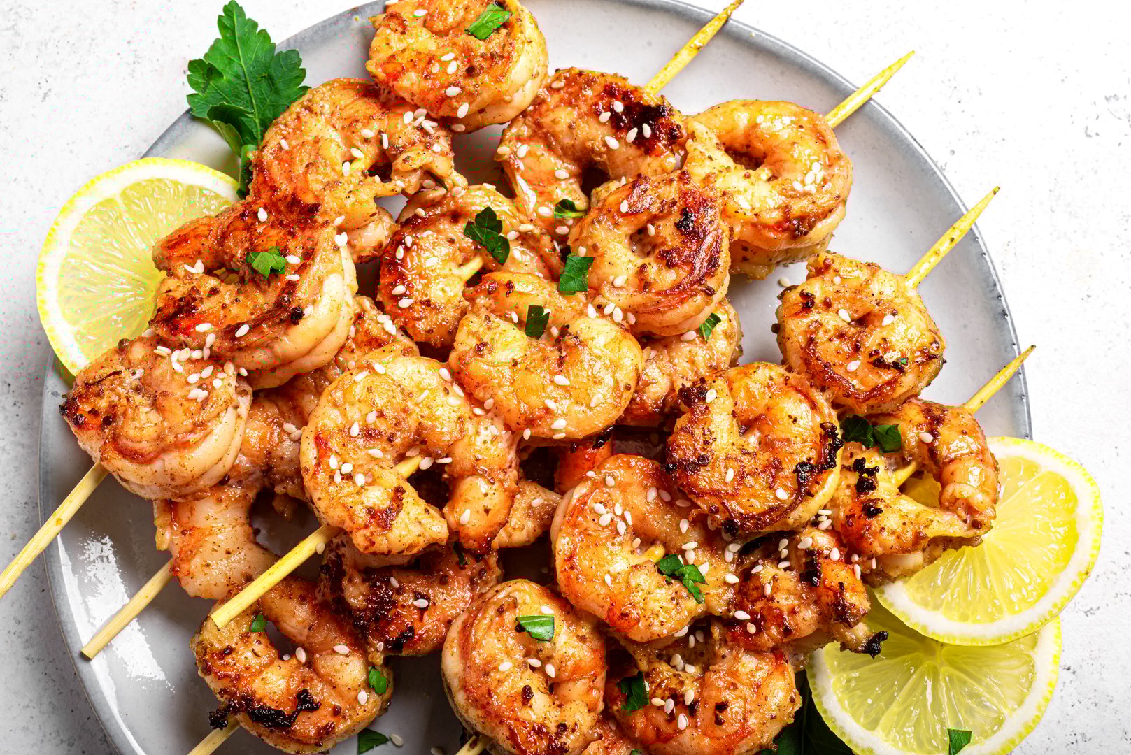 Grilled shimp prawn skewers close up. Honey garlic roasted shrimp kebabs. Thai asian style party meal.