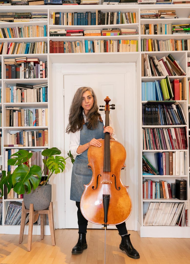 Close up of skilled craftsman carefully carving a violin scroll in a traditional lutherie workshop with attention to detail and precision