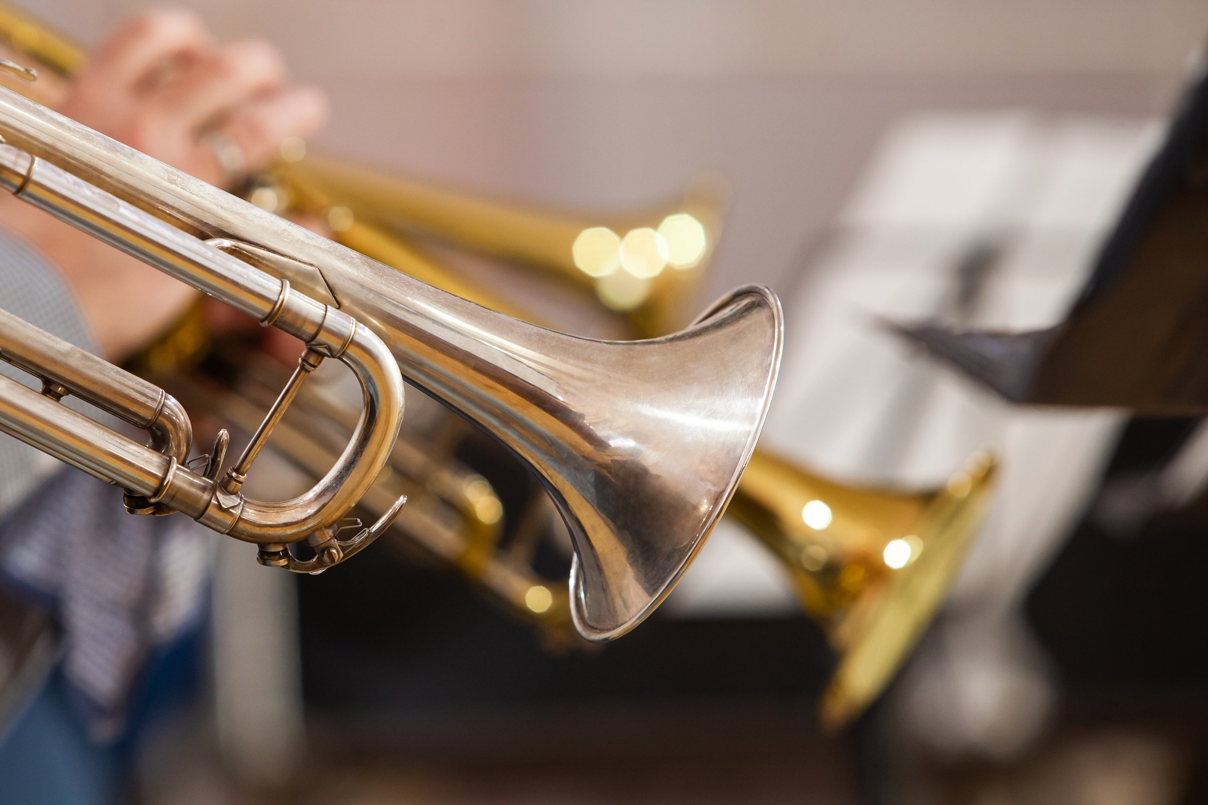 Trumpets in the hands of musicians in the orchestra close-up