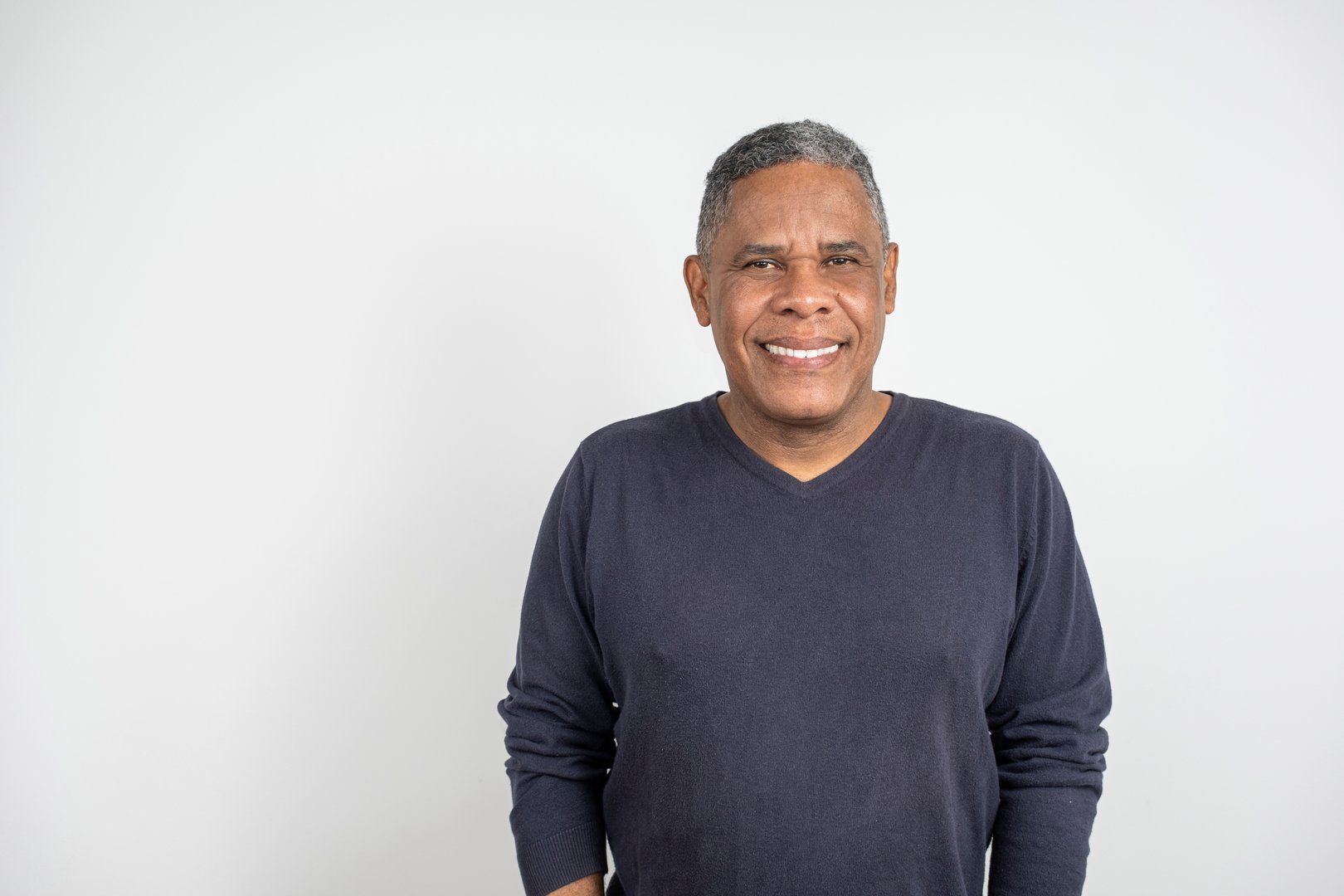 51 year old Brazilian man, black and smiling, facing the camera.