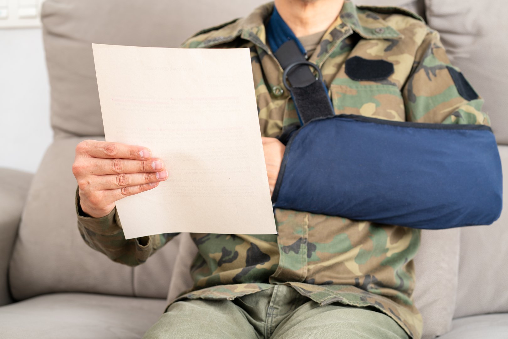 Reading letter about Injury and soldier compensation paperwork, insurance, legal contract or lawyer consulting. Disability people, attorney or advocate in negotiation, policy advice or accident report closeup