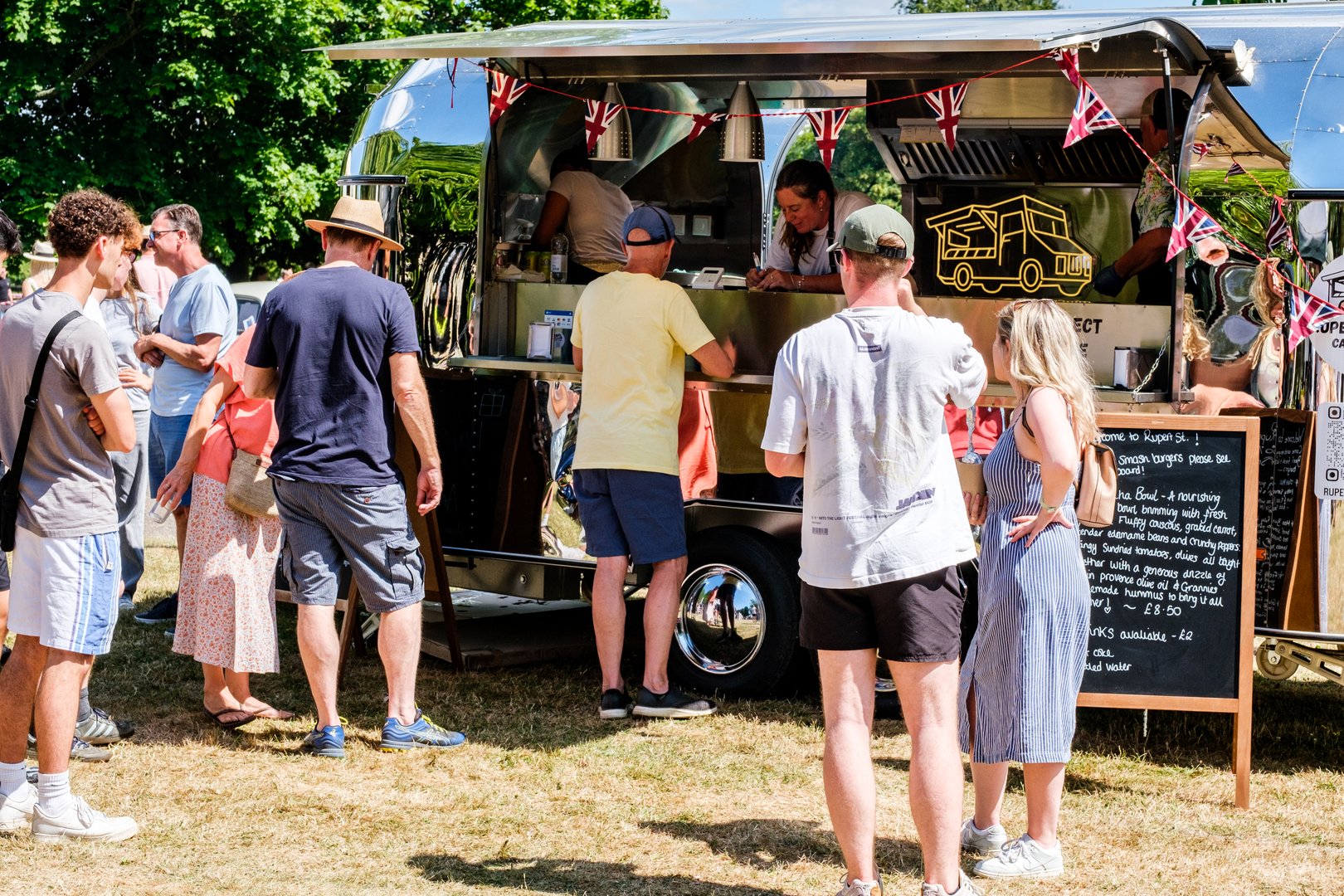 London UK,  June 29 2025, People Queing to Buy Food From A Mobile American Style Food Truck