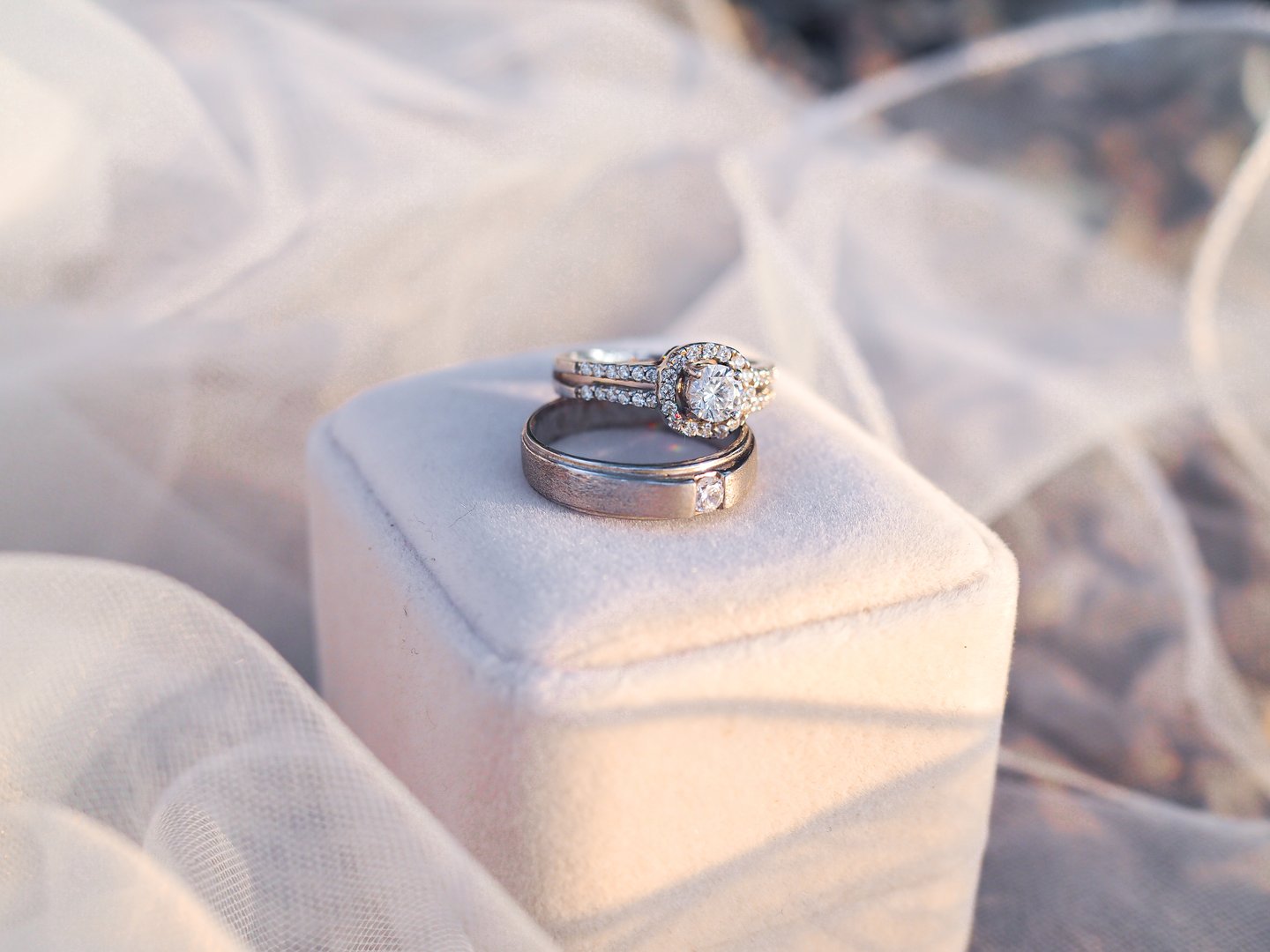 Diamond engagement wedding rings with bridal veil on rings box. Wedding accessories. Valentine's day and Wedding day concept.