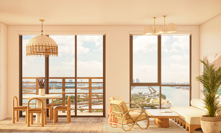 Bright living room with ocean view, rattan furniture, a large window, and warm wooden accents.