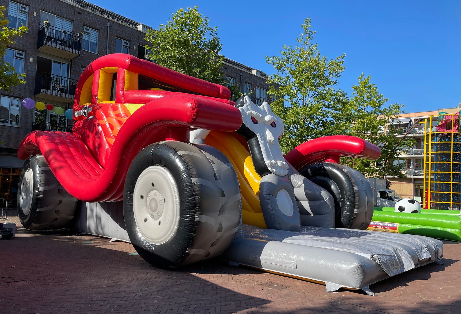 Hardenberg, the Netherlands - August 14 2021 - An event agency is building bouncing objects for children in the middle of the city center. This Monster truck bouncy castle is 6 meters high.