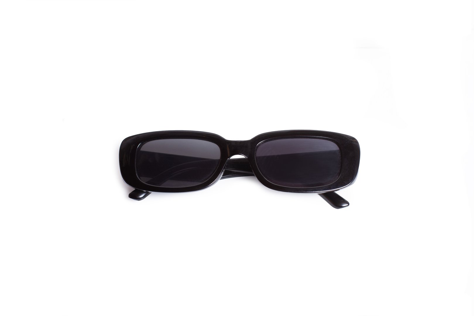 Black plastic frame sunglasses isolated on a white background with copy space