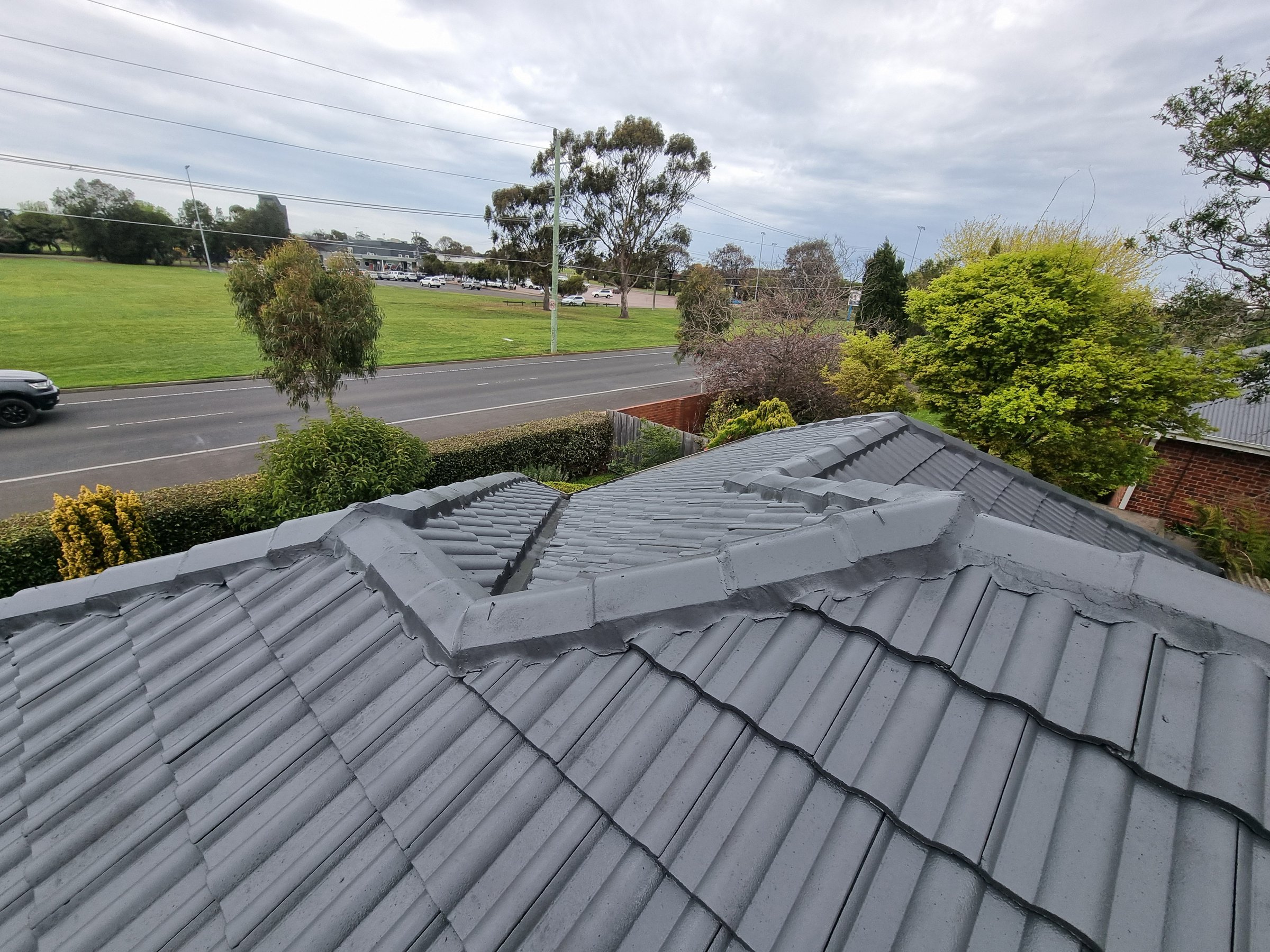 Quality Painting Group tile roof after restoration showing clean and restored condition