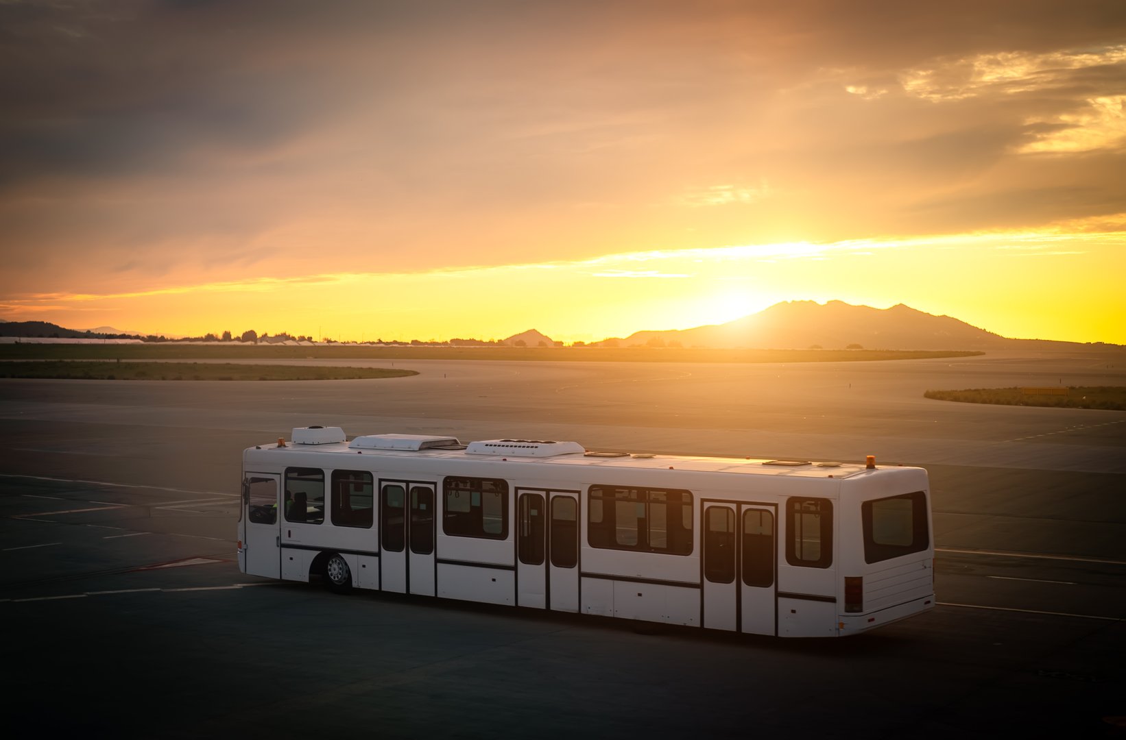 Airport shuttle bus at sunset