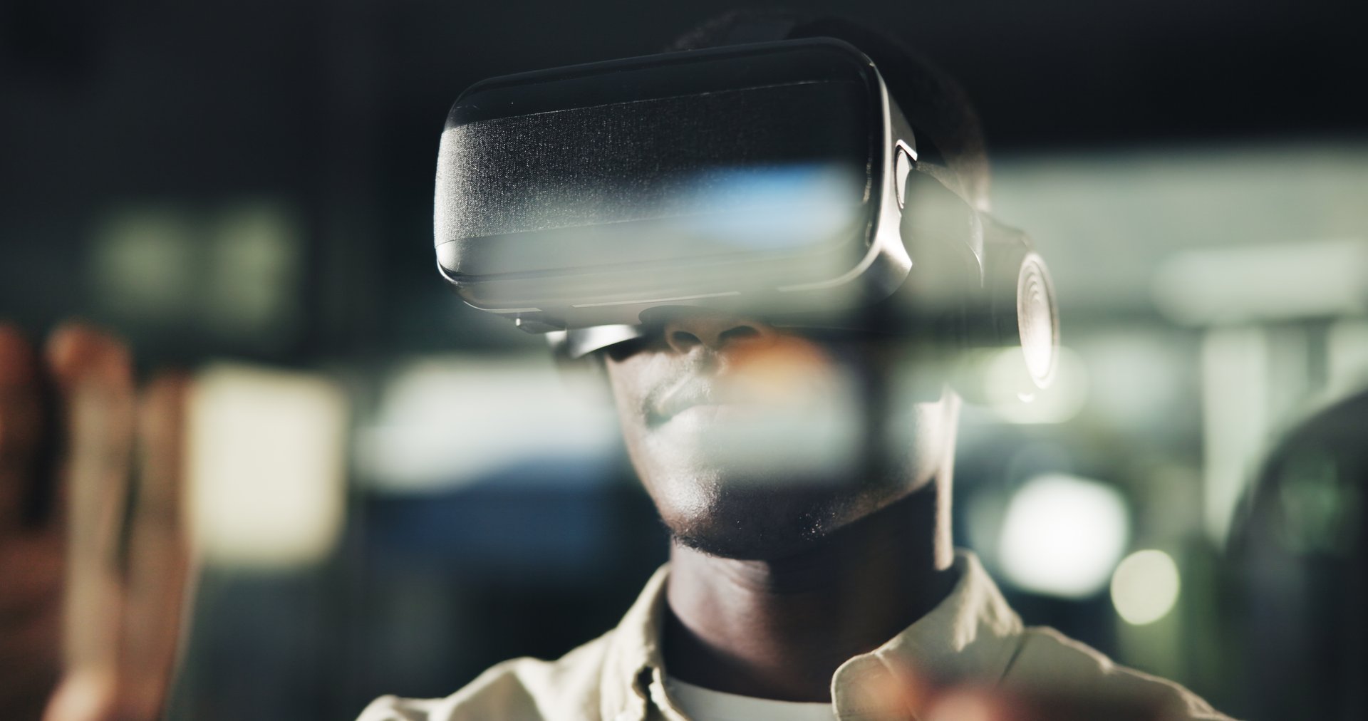 Night, black man and VR tech in office with interaction, user experience and design at window. Late work, reflection and employee with AR goggles for virtual editing, creativity or future application