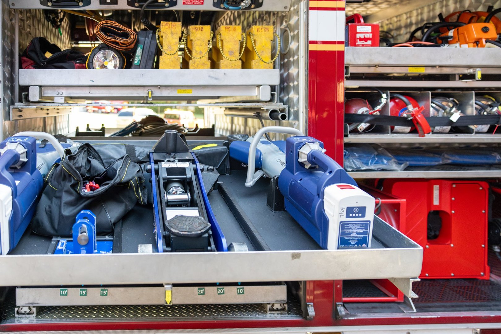 jaws of life, oxygen, jacks and other tools for fire and rescue inside of a firetruck