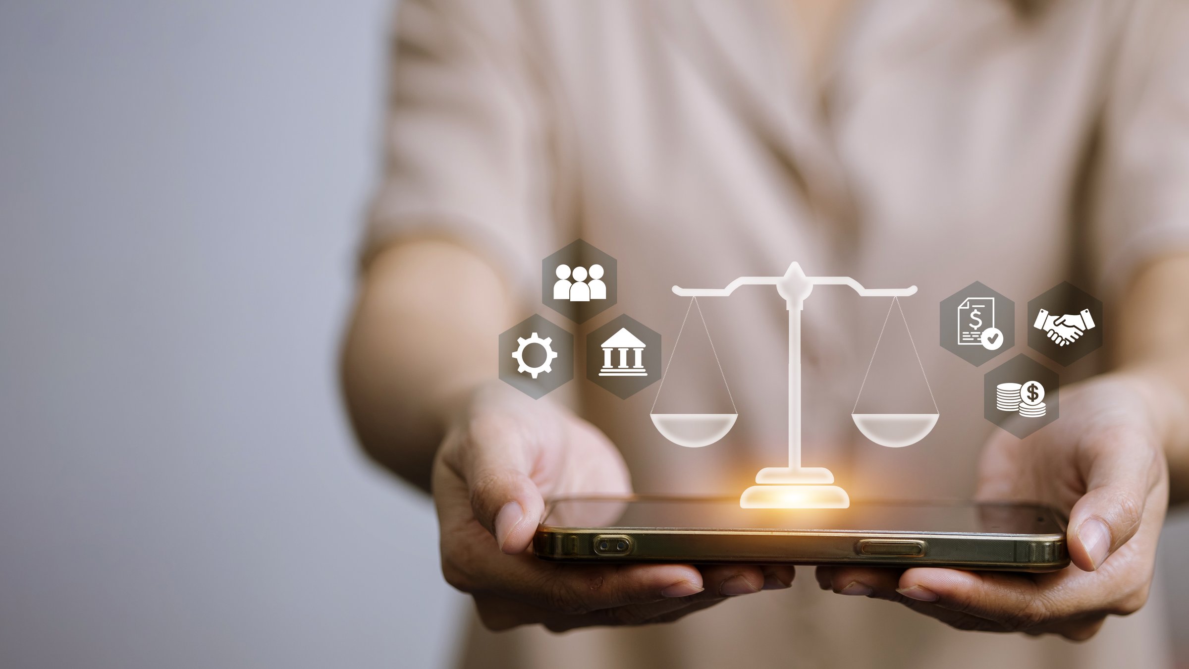 Legal technology and fintech innovation concept showing balance scale and finance icons on smartphone, representing digital justice, regulation, and smart finance system.
