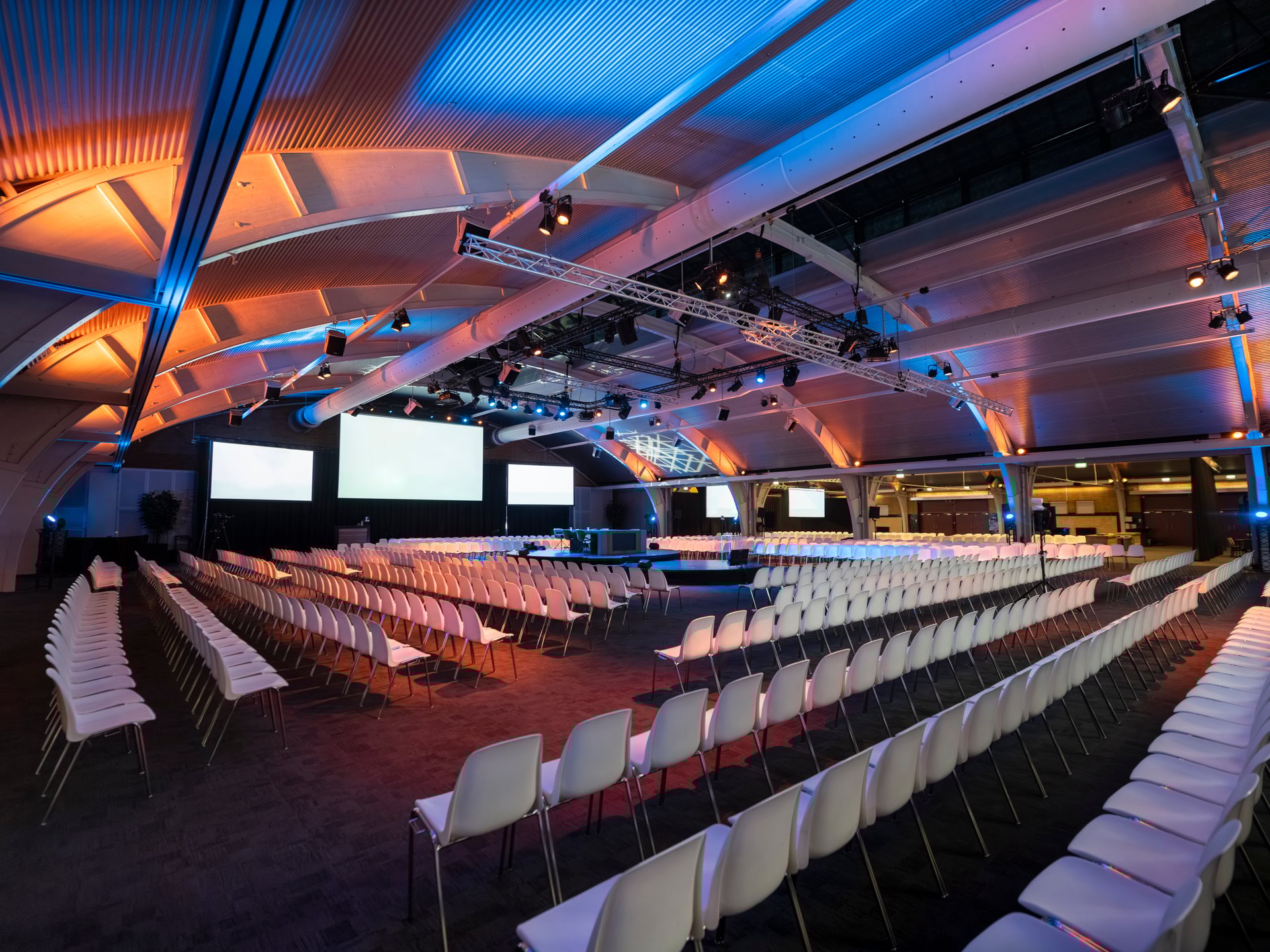 a large congress hall with seating and a podium