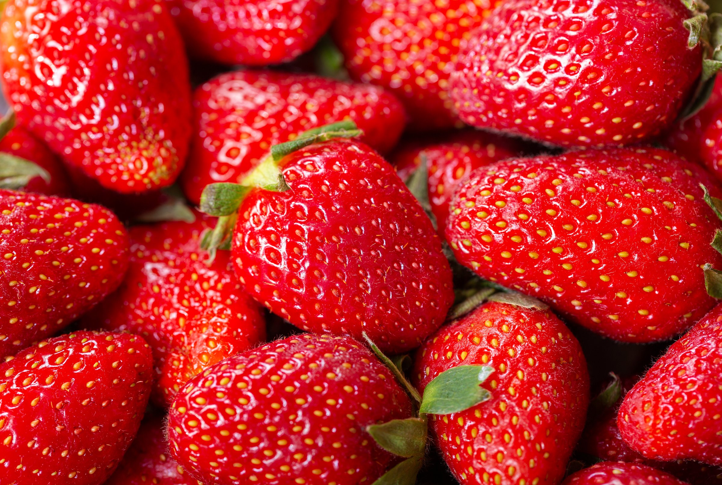 close up of fresh strawberries as background