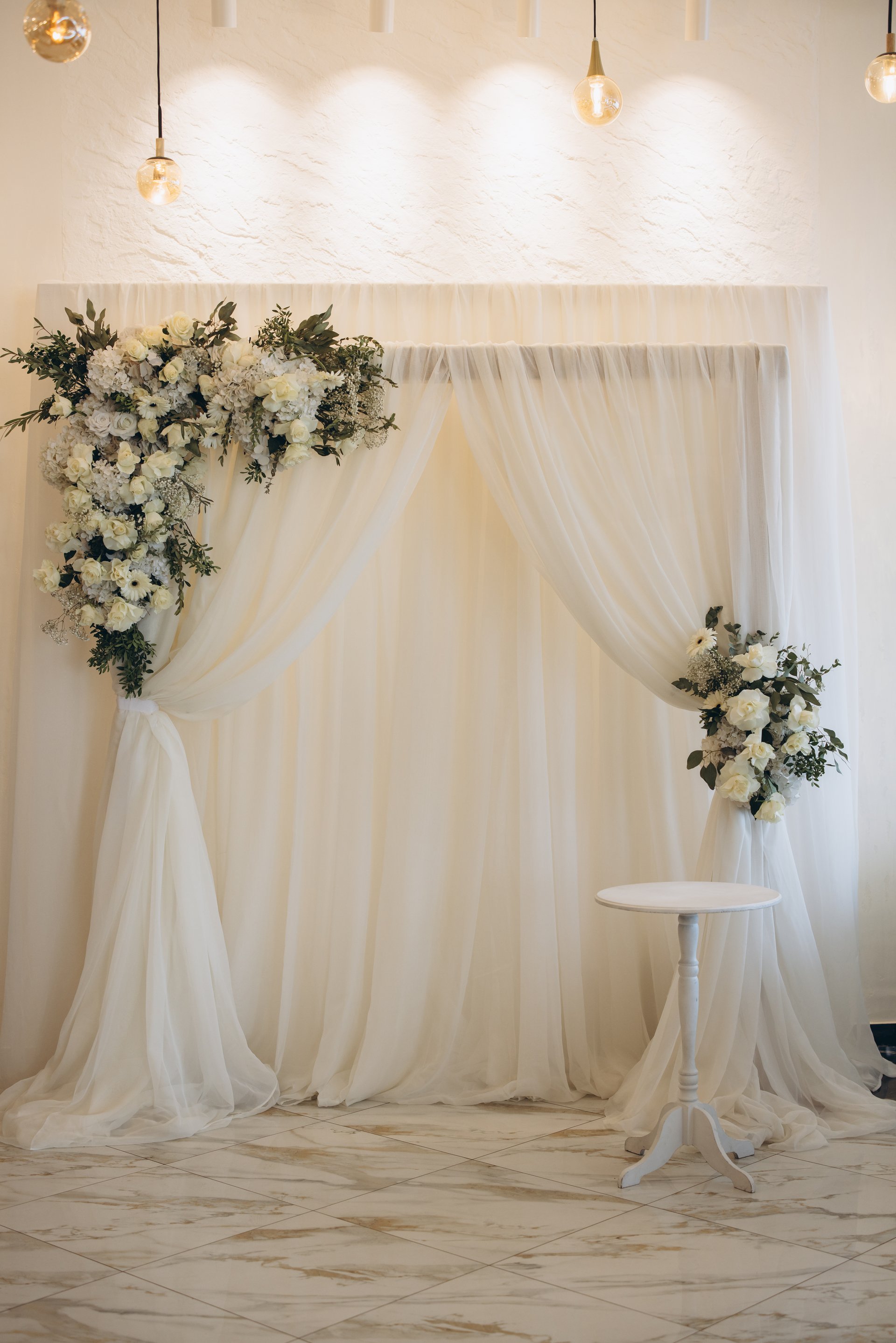 Elegant wedding arch adorned with white flowers