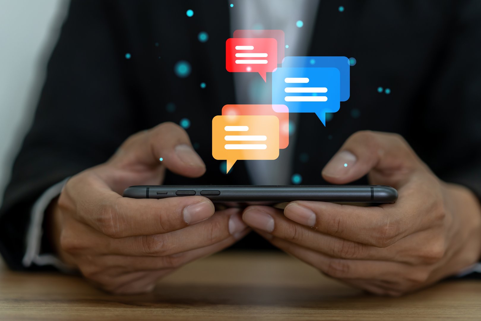 Human hand using smartphone typing Live chat chatting and social network concepts, chatting conversation working at home in chat box icons pop up. Social media marketing technology concept