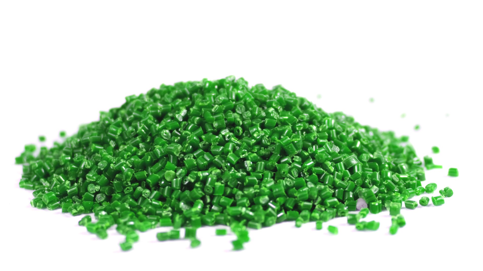 Secondary granule made of polypropylene, green Plastic pellets crumbles to the table. Plastic raw materials in granules for industry. Polymer resin. Raw plastic recycling concept.