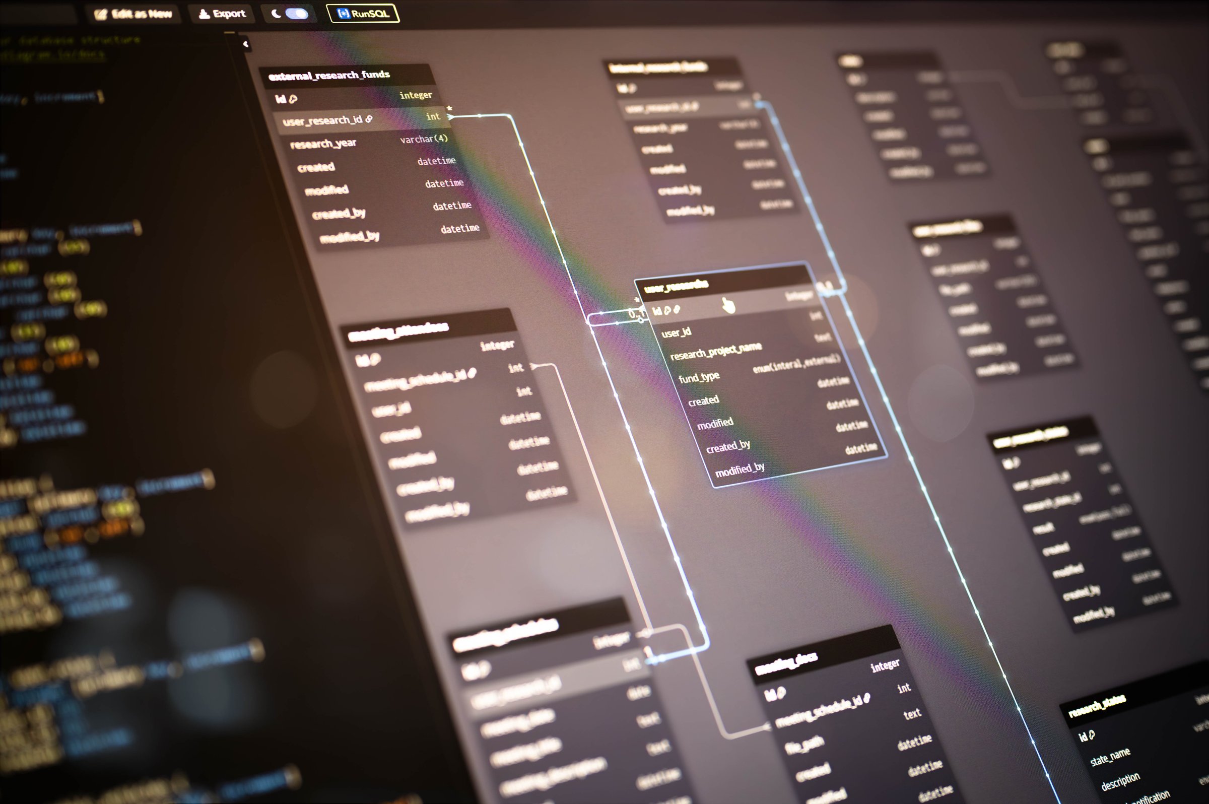Detailed view of entity relationship diagram (ERD) with SQL code on a computer screen, illustrating database relationships and system structure for backend software architecture projects.