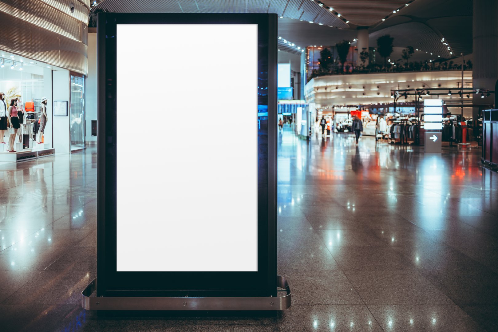 Blank digital advertising screen mockup in a modern airport terminal. Vertical billboard ready for branding, product promotion, or commercial use. Surrounded by retail stores and glossy floor
