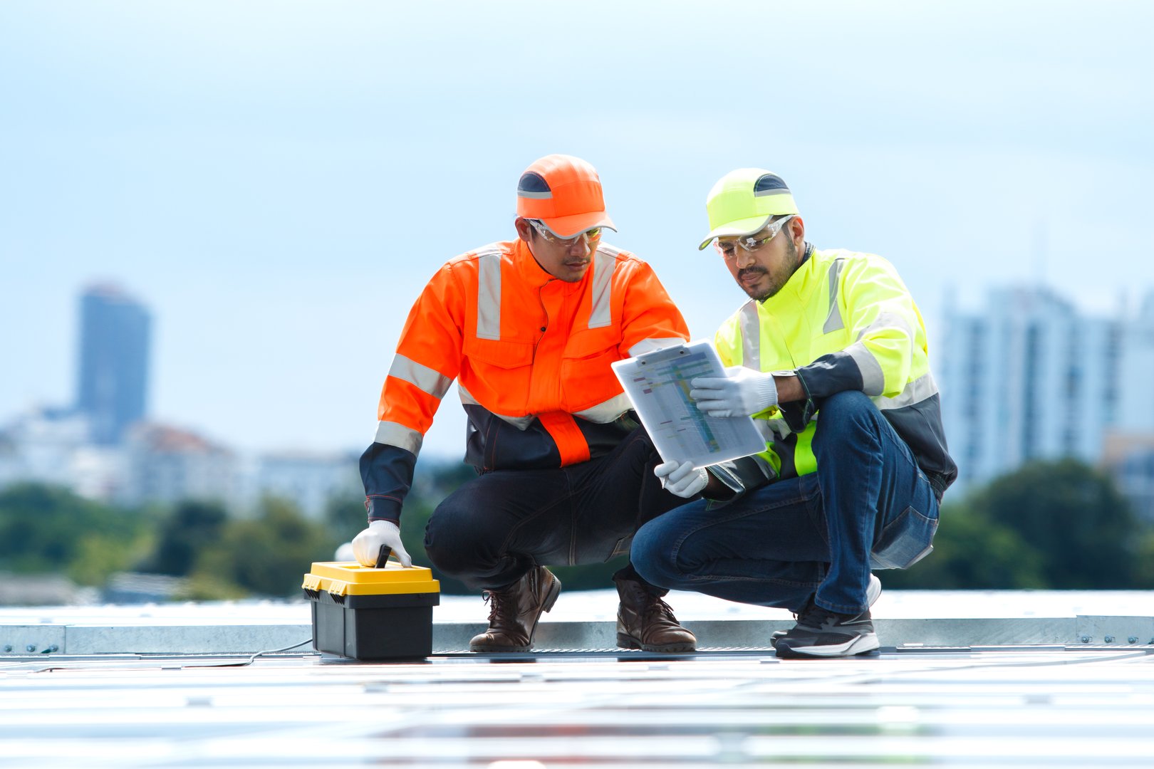 Team installing solar panels on rooftop