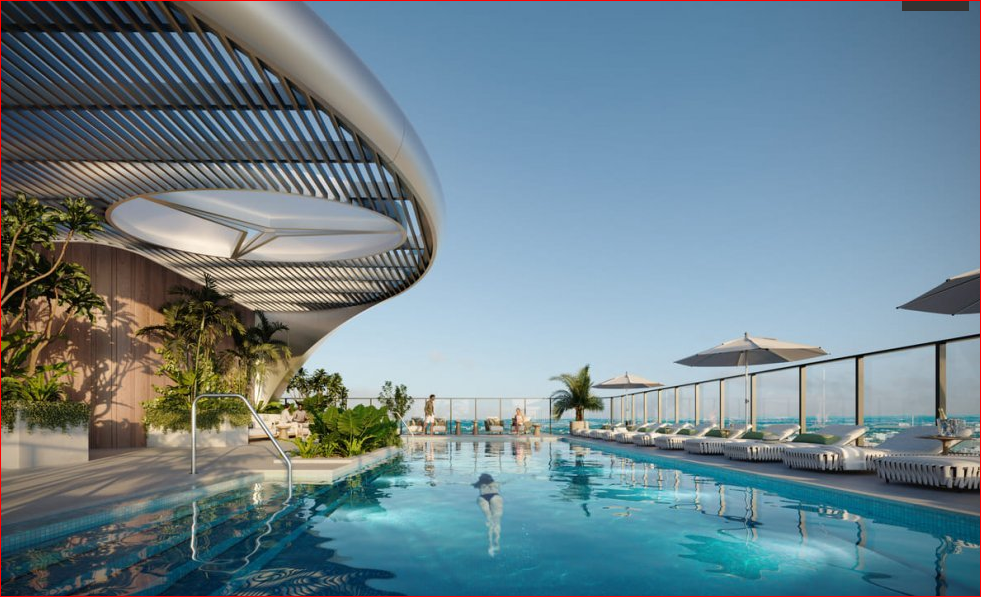 Rooftop infinity pool with loungers, umbrellas, and ocean view, under a modern sunshade structure.