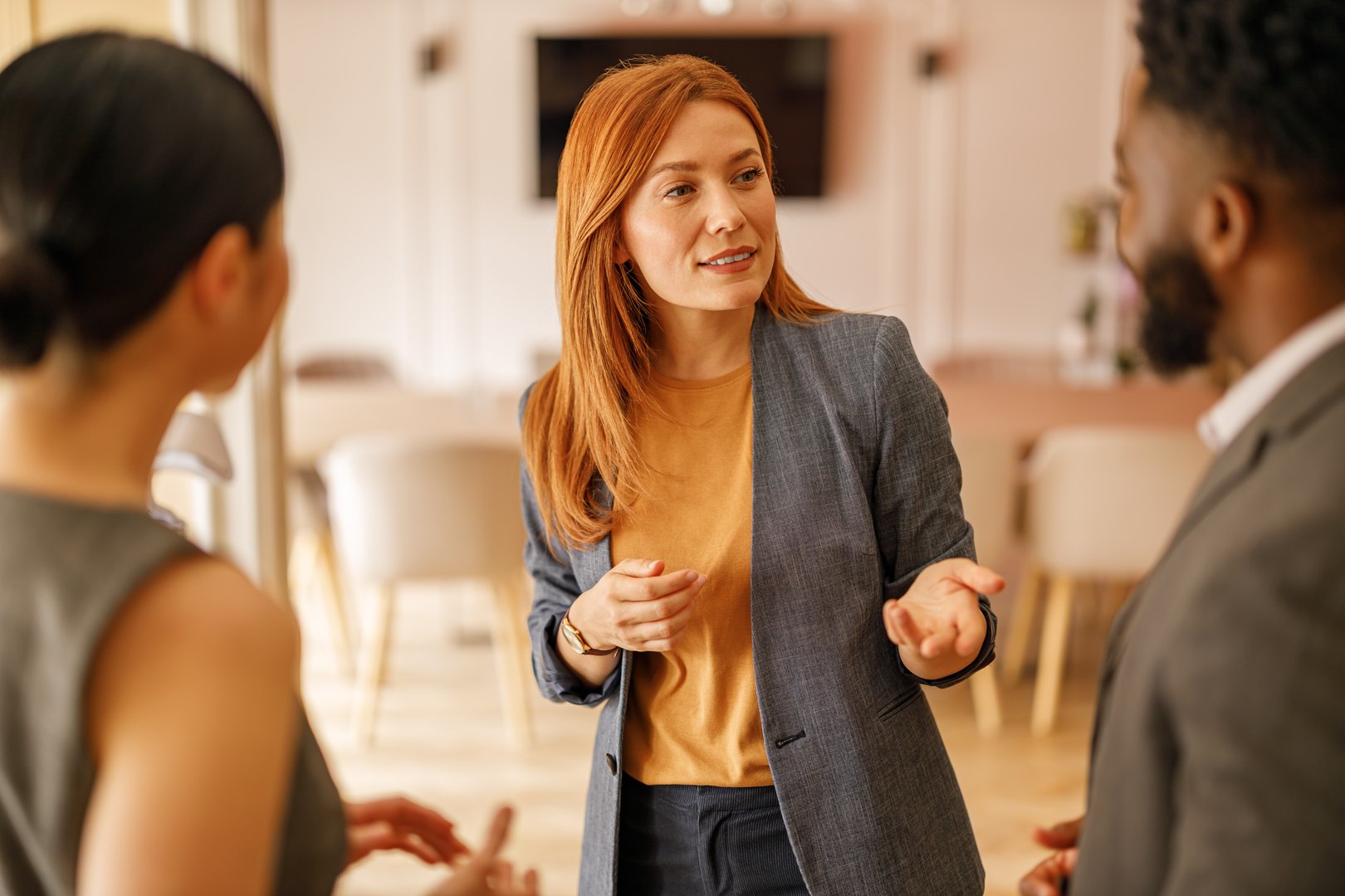 Confident executive discussing financial strategies and planning with coworkers in office for business growth
