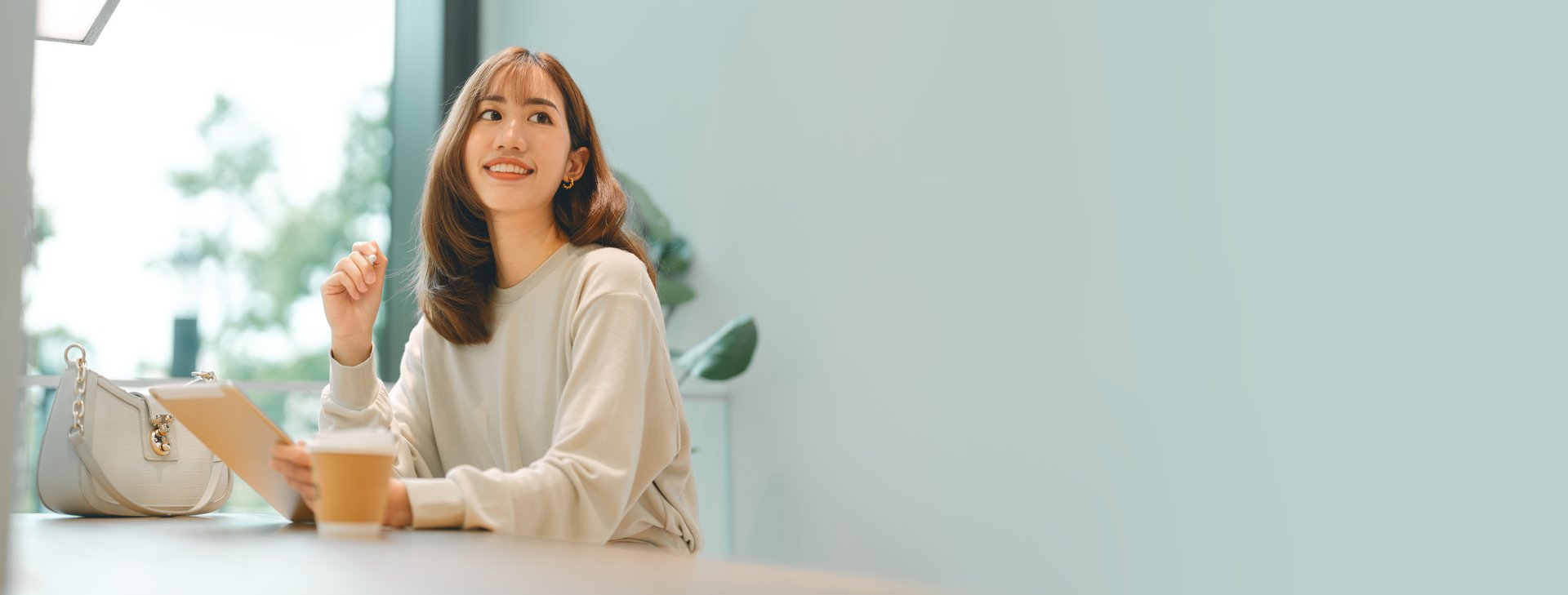 People working and relax at cafe. Adult asian business woman using digital tablet writing daily journal drinking coffee. Female sitting at indoors with copy space. Lifestyle with modern technology