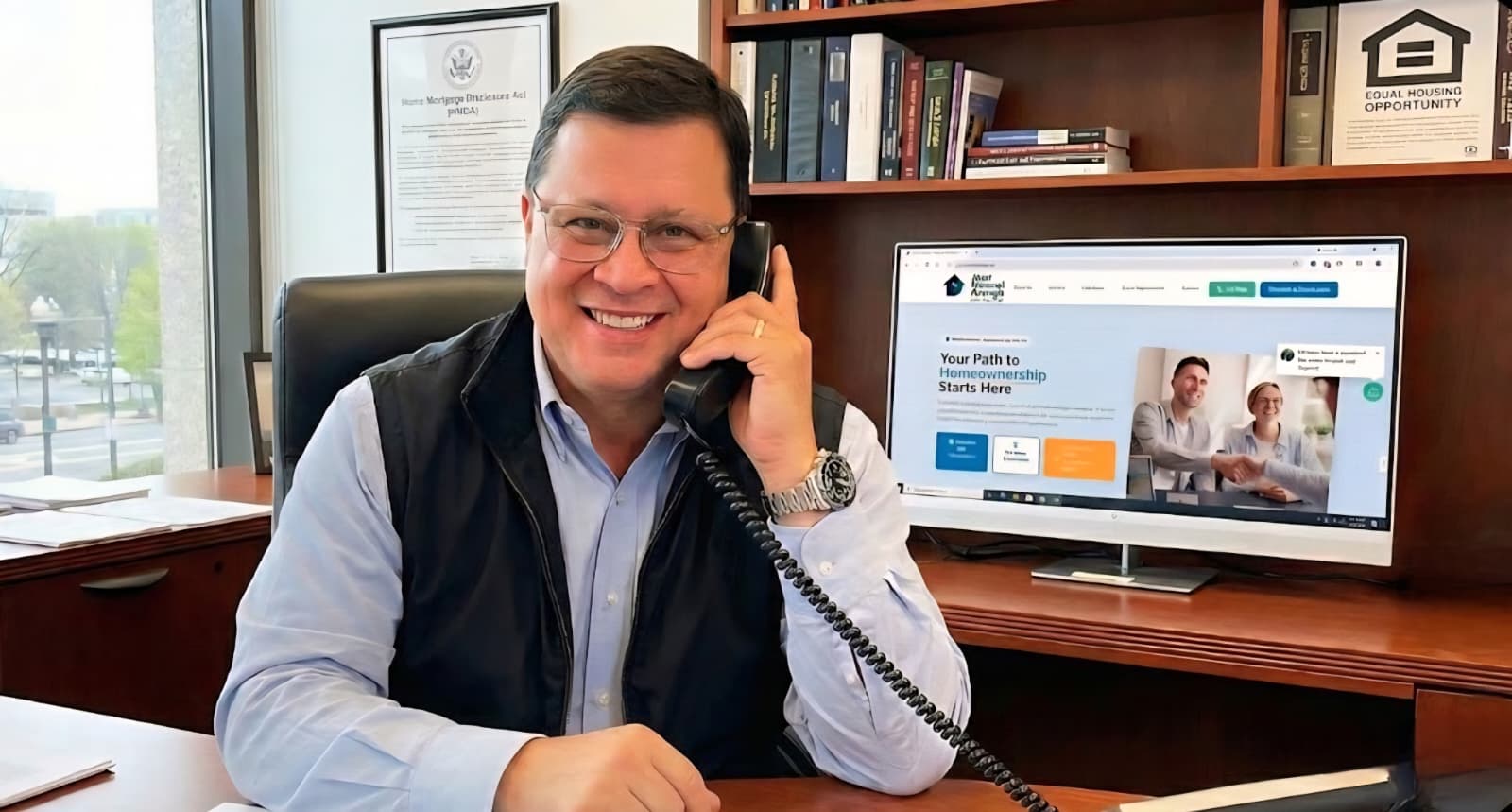 Jose Manuel Arango assisting customer with loan application