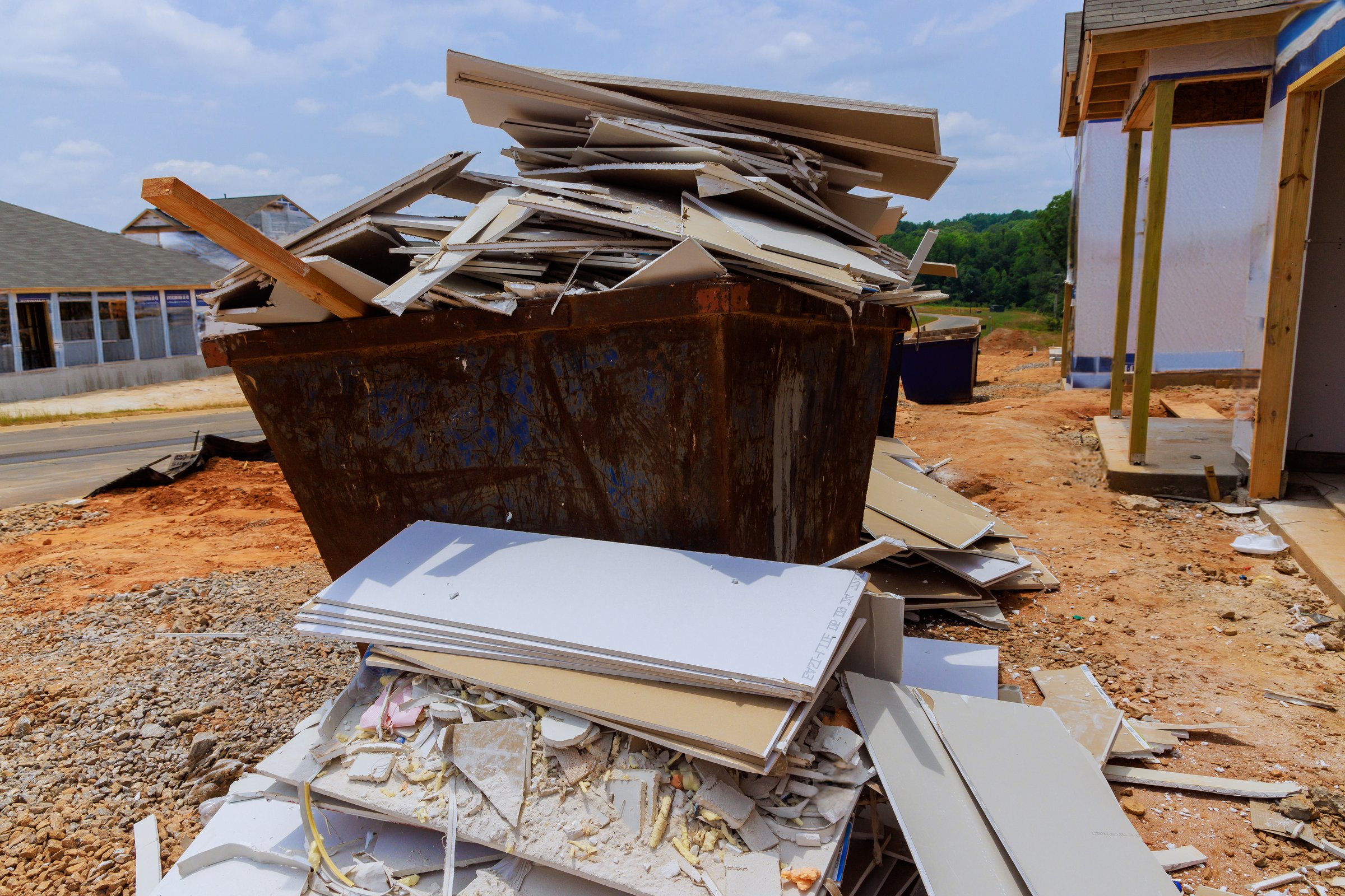 Remains of plasterboard drywall were placed in construction waste container
