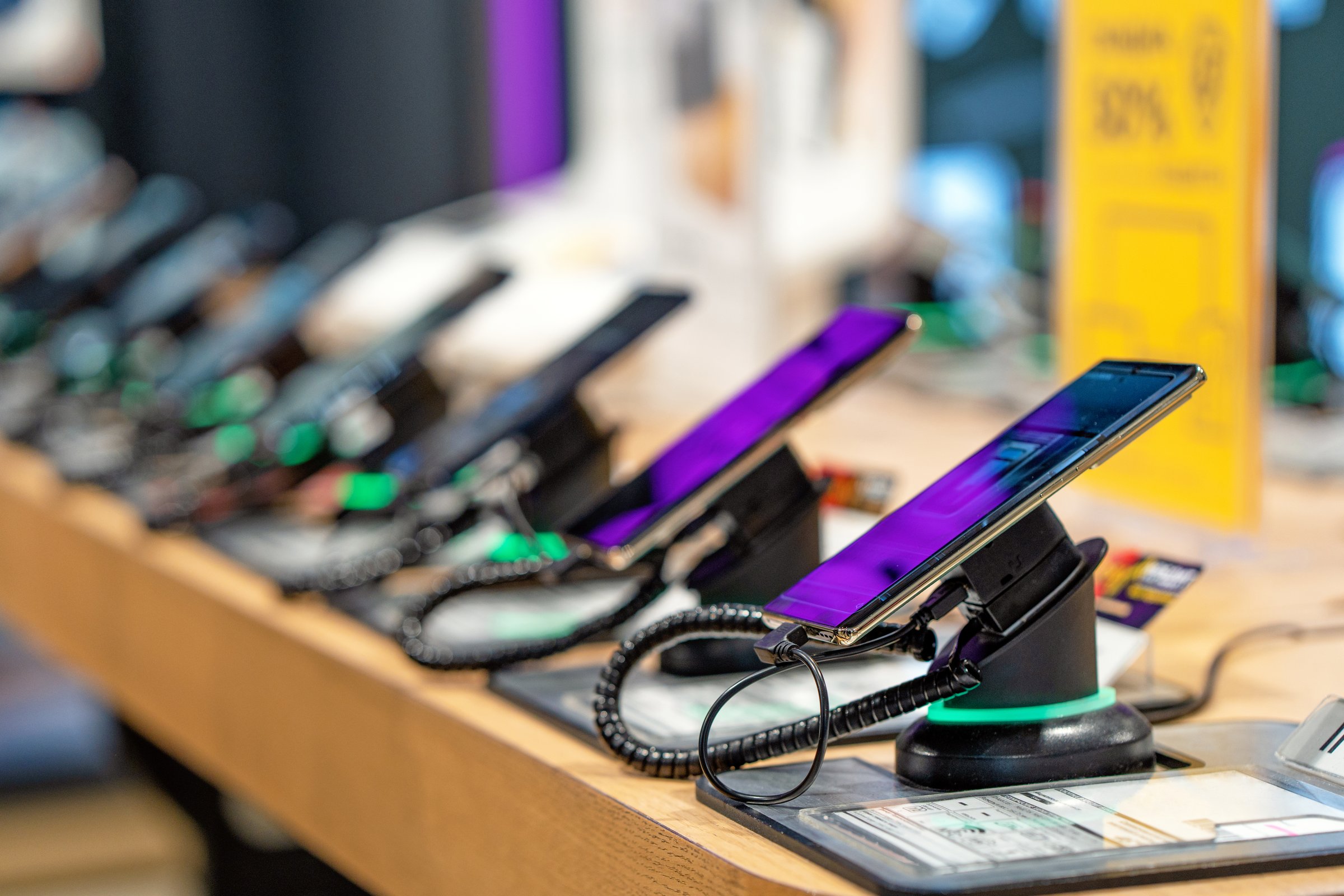 Buy a mobile phone. Many smartphones on the shelf of the technology store