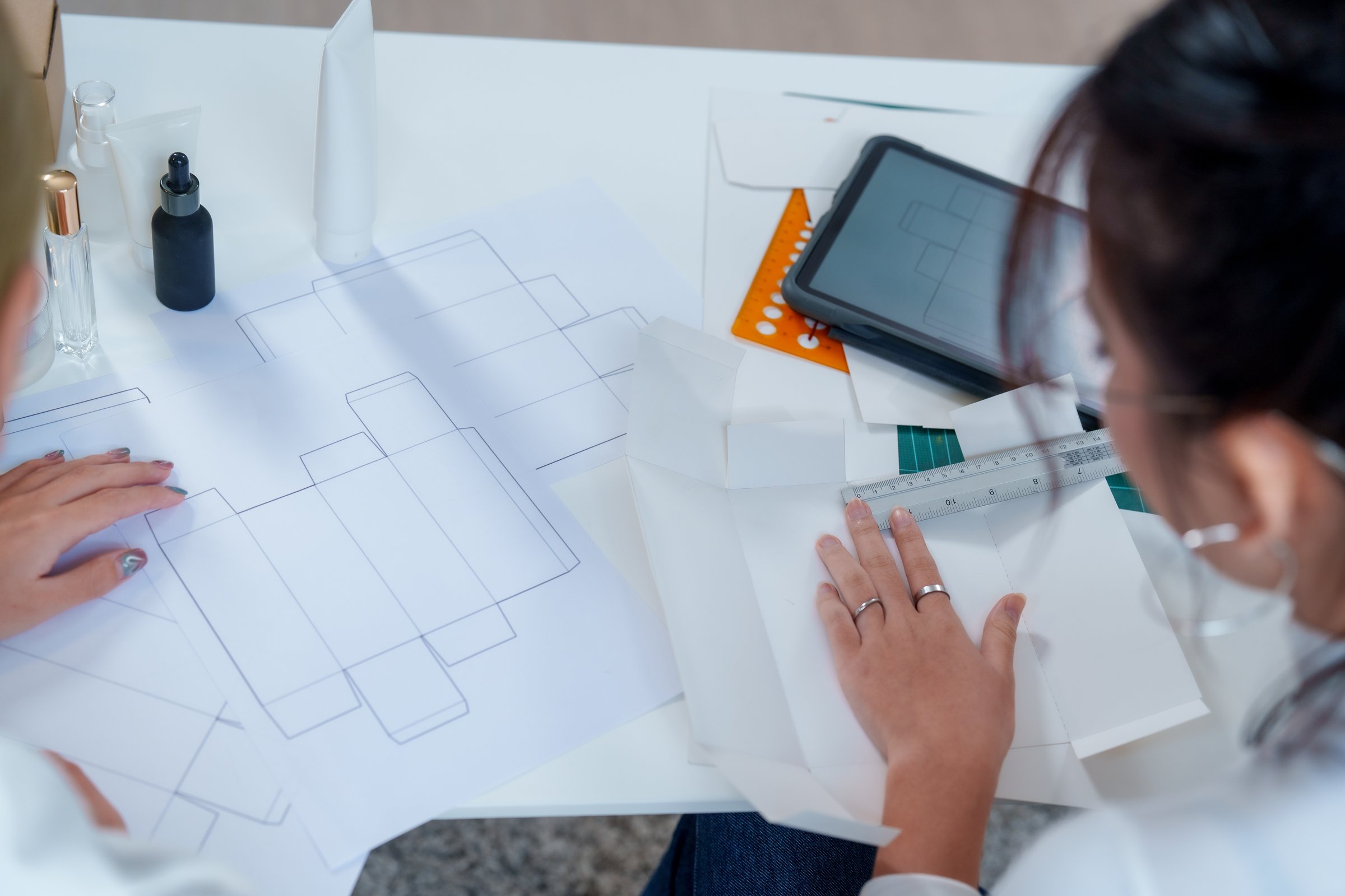 Creating innovative cosmetic packaging requires thorough market research and thoughtful design to enhance product development. collaborative effort shown here highlights importance of teamwork