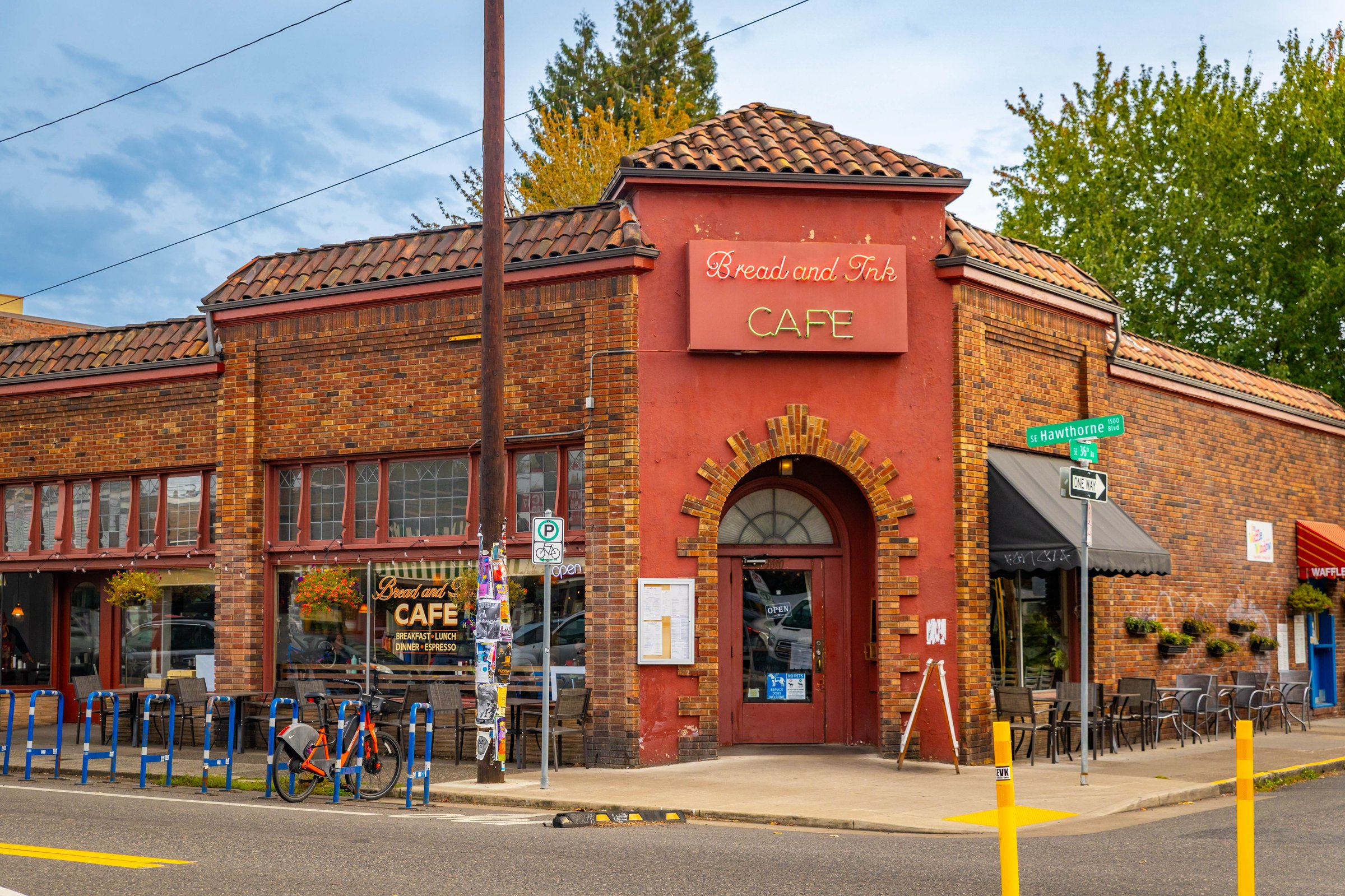 Portland, OR, USA - October 09, 2025: The bustling downtown streets of Portland are vibrant with activity and framed by trees displaying their colorful autumn foliage