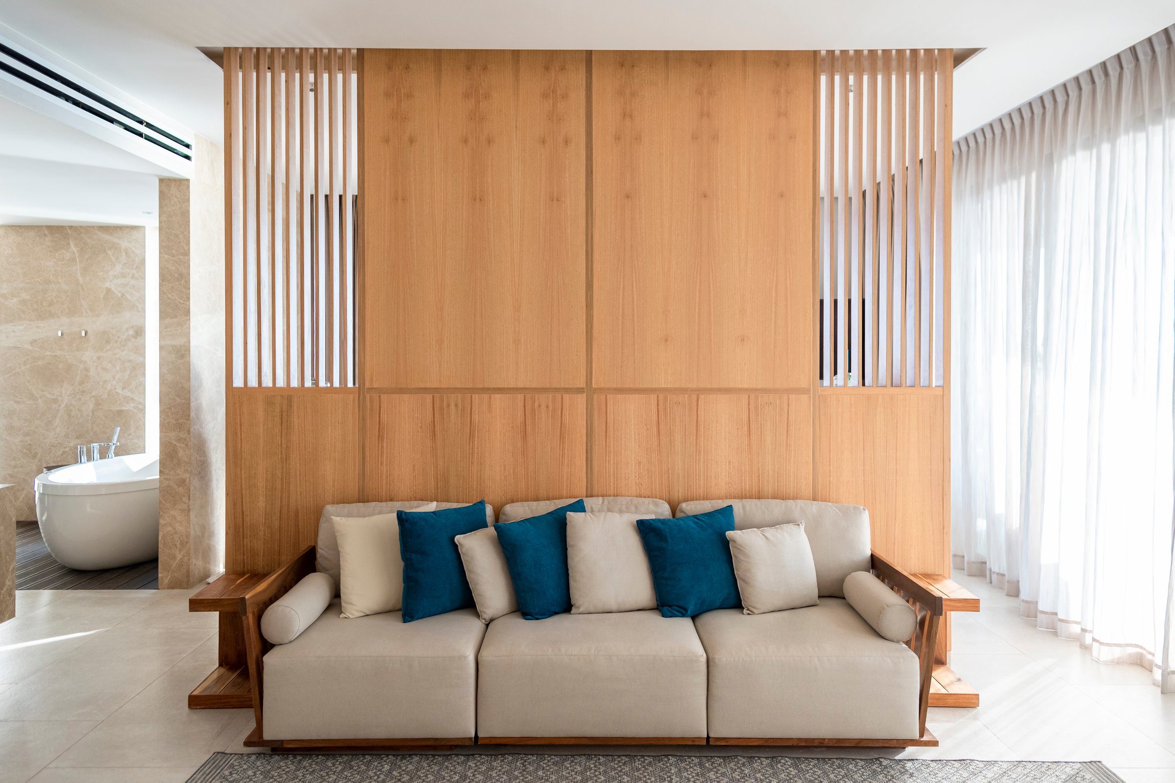 Beige Sofa, in wooden wall background, modern bedroom whit bathtub, vertical orientation