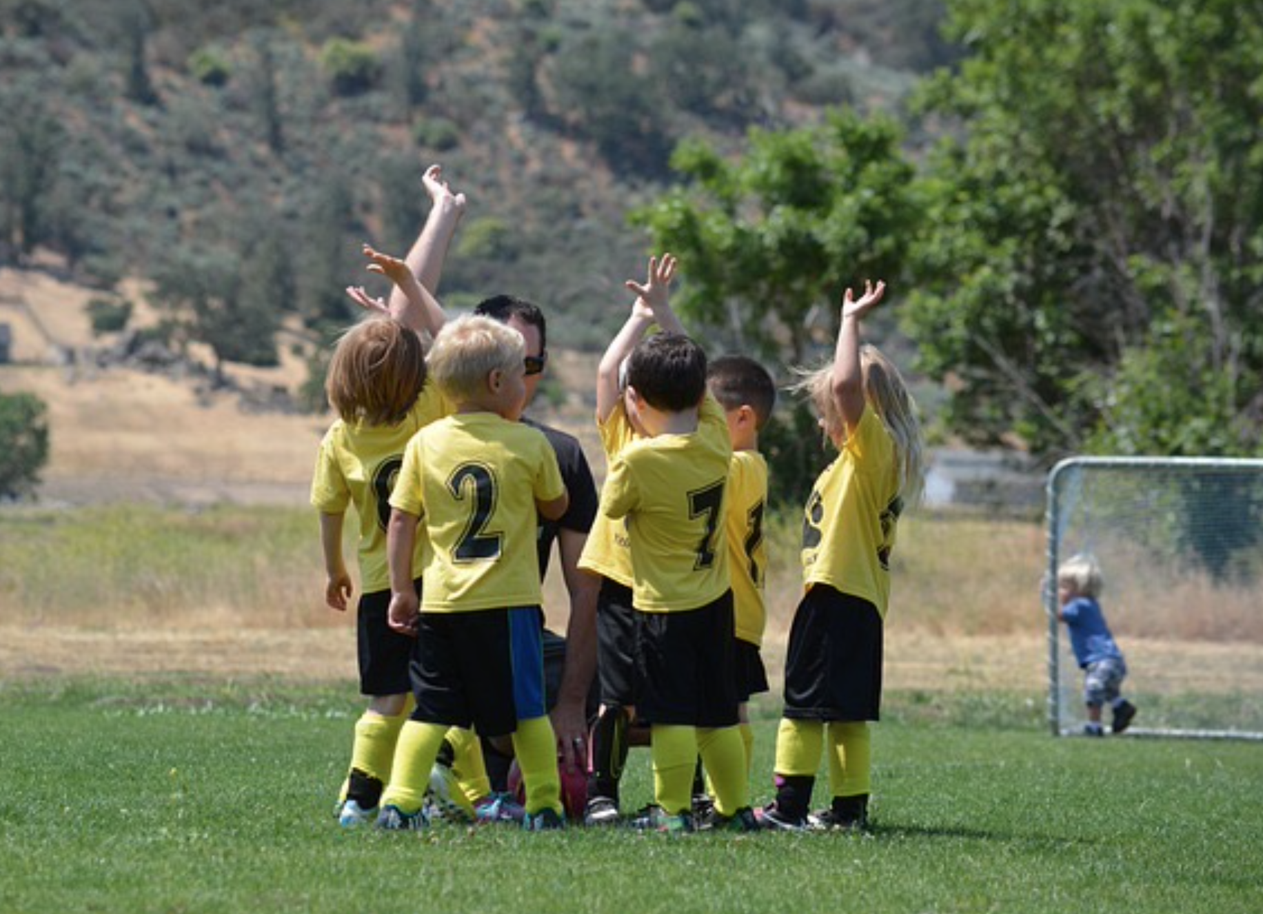 Young children playing soccer in a safe environment