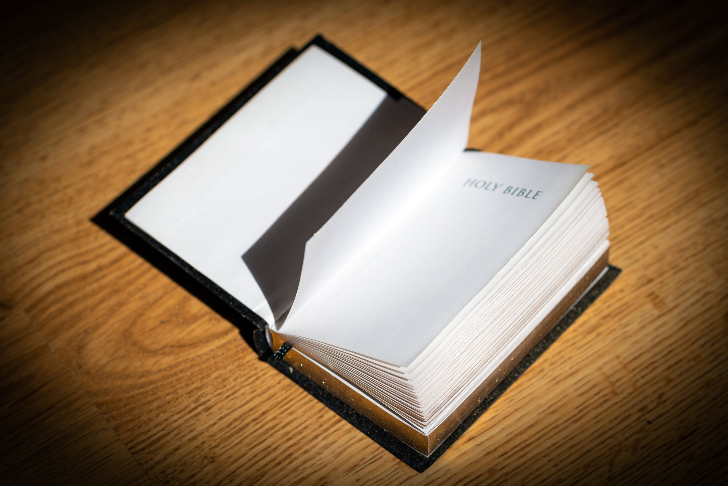 Open Holy Bible on a brown wooden table.Open Holy Bible top view.Religious concept.