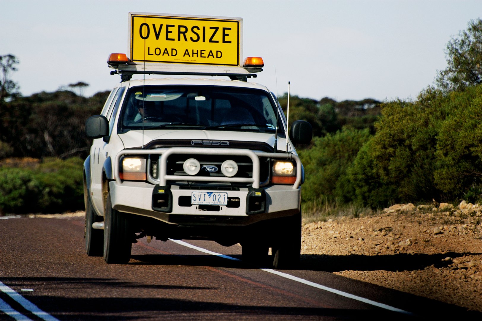 Victoria, Australia - may 20, 2007: Safety car following a huge wide truck to alert other users of the danger on a road Australian road