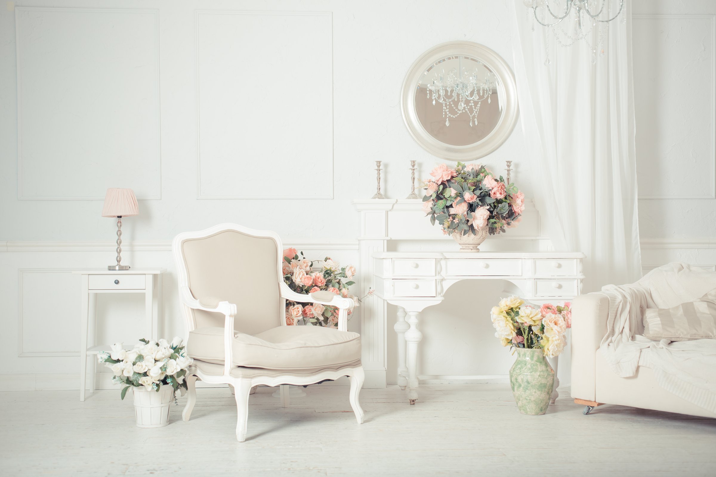 luxury clean bright white interior. a spacious room with sunlight and flowers in vases