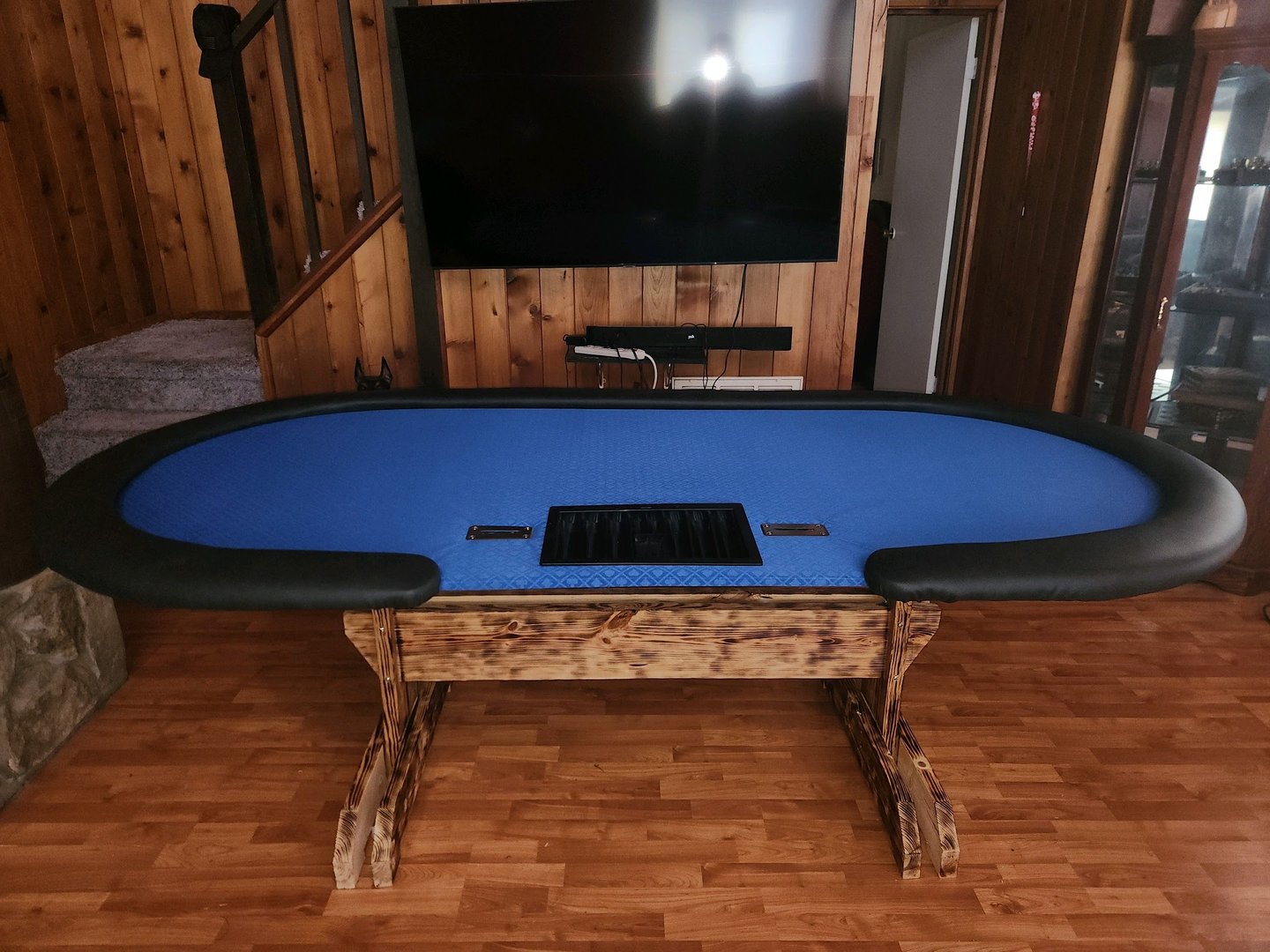 Blue poker table with chip drops
