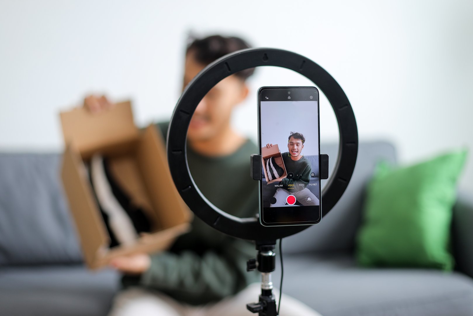 Happy Male Influencer Showcasing New Pair Of Shoes For His Online Live Video
