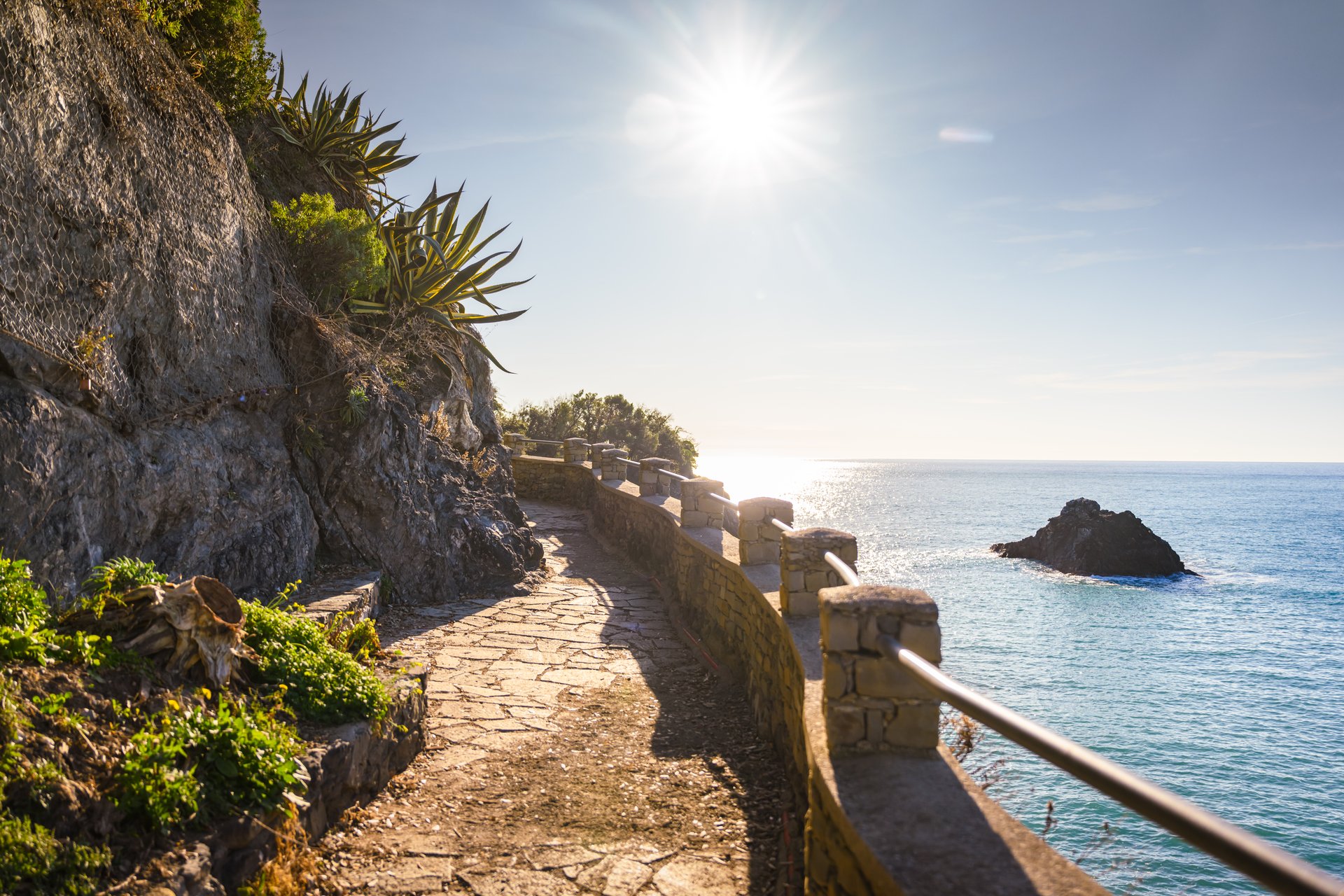 View on the footpath Via dell'Amore in Cinque Terre National Park area, Liguria, Italy. Mediterranean sea and coastline on sunny summer day. Landscape photography