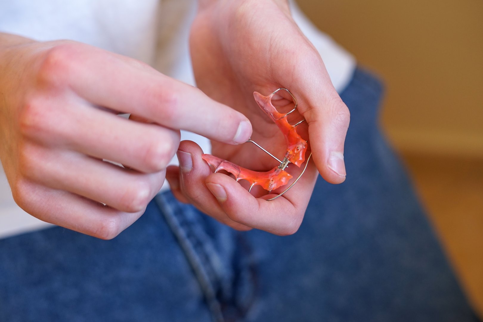 A person adjusting a palatal expander used to widen the upper or lower jaw in orthodontics