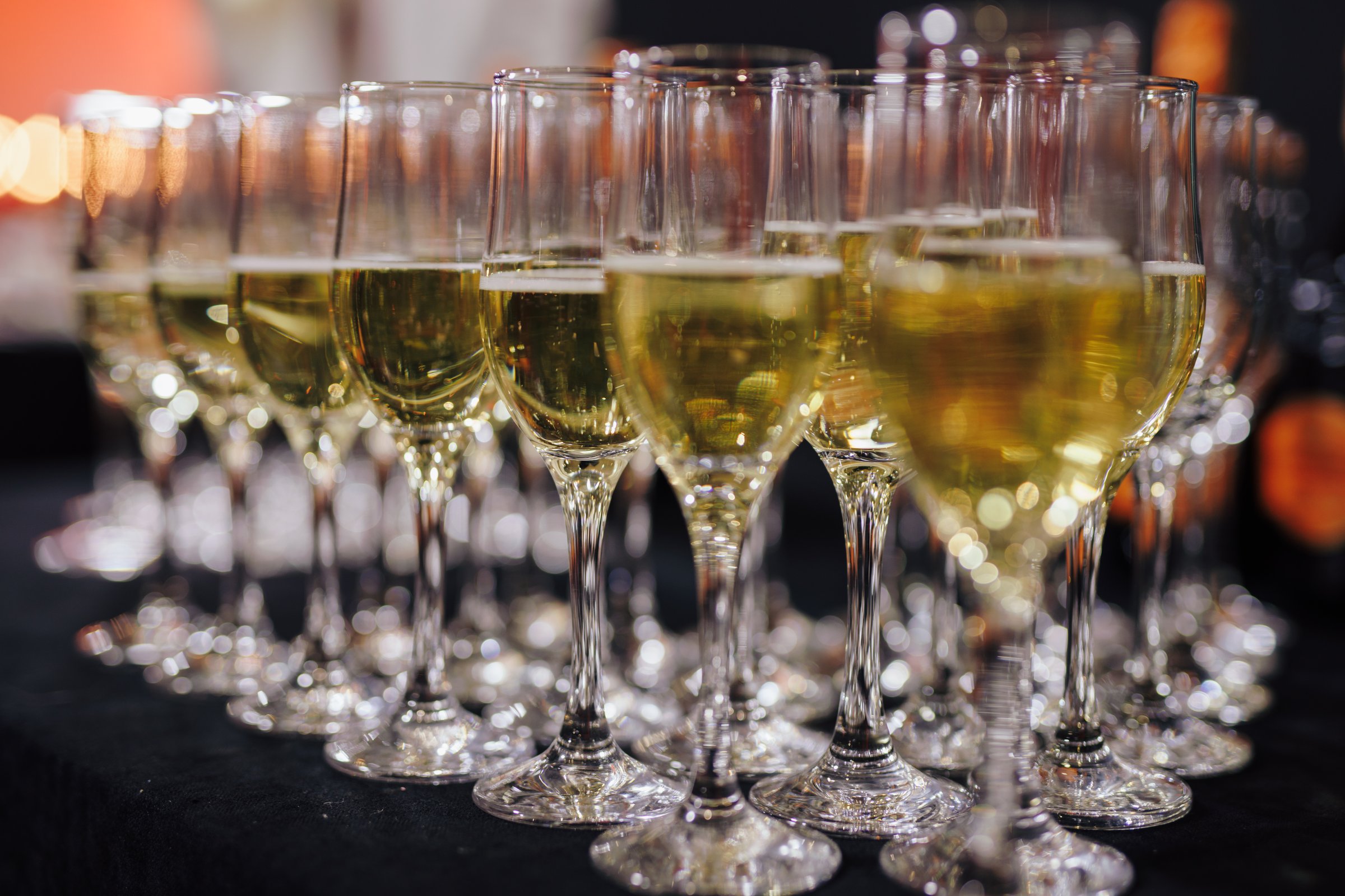 A row of champagne on the table at event