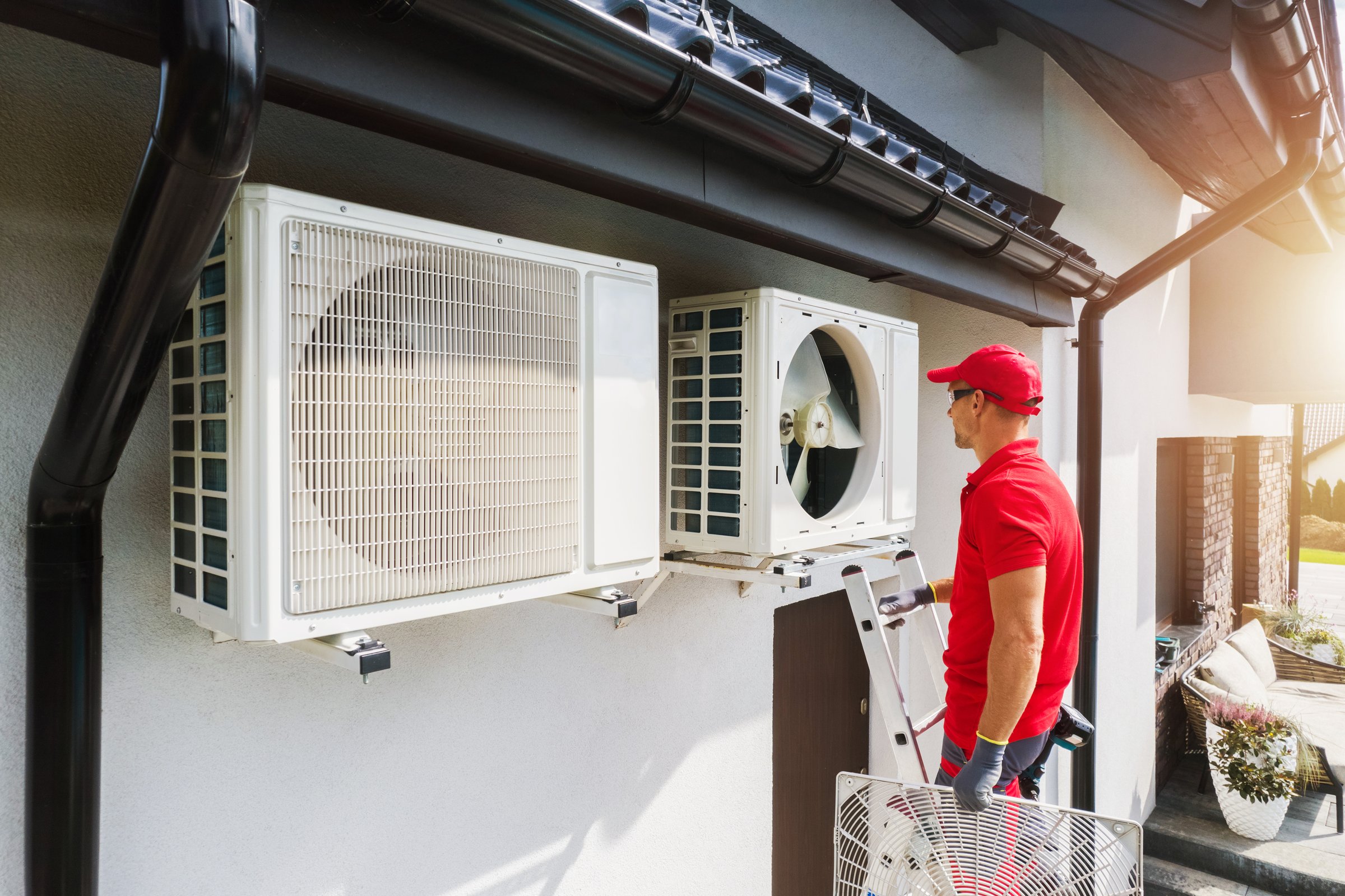 A Caucasian Professional HVAC Technician Performing Air Condition and Heat Pump Units Maintenance